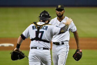 MIAMI, FL - MAY 19: Sandy Alcantara #22 of the Miami Marlins celebrates with catcher Chad Wallach #17 after pitching a complete game against the New York Mets at Marlins Park on May 19, 2019 in Miami, Florida. (Photo by Eric Espada/Getty Images)