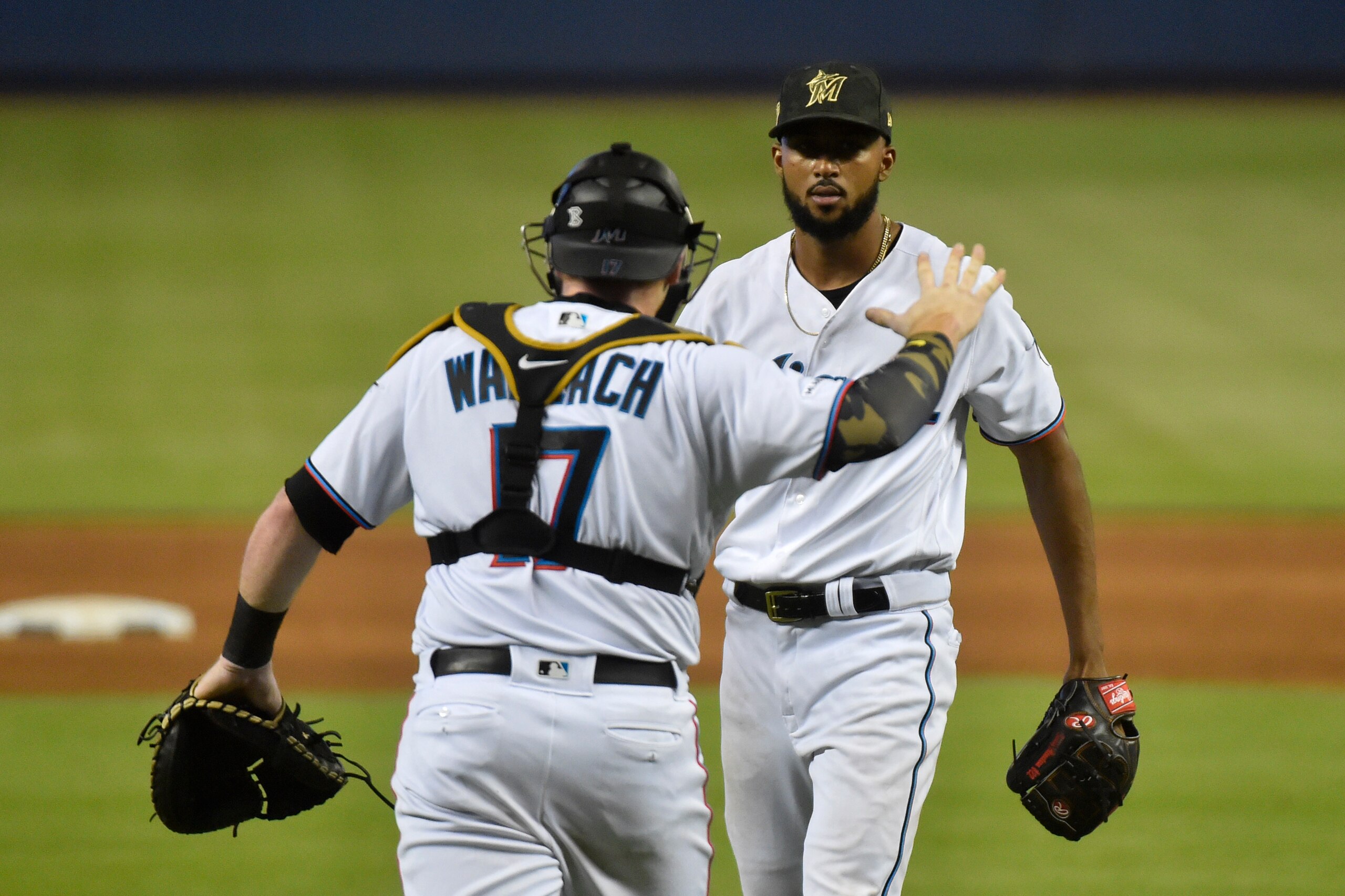 MIAMI, FL - MAY 19: Sandy Alcantara #22 of the Miami Marlins celebrates with catcher Chad Wallach #17 after pitching a complete game against the New York Mets at Marlins Park on May 19, 2019 in Miami, Florida. (Photo by Eric Espada/Getty Images)