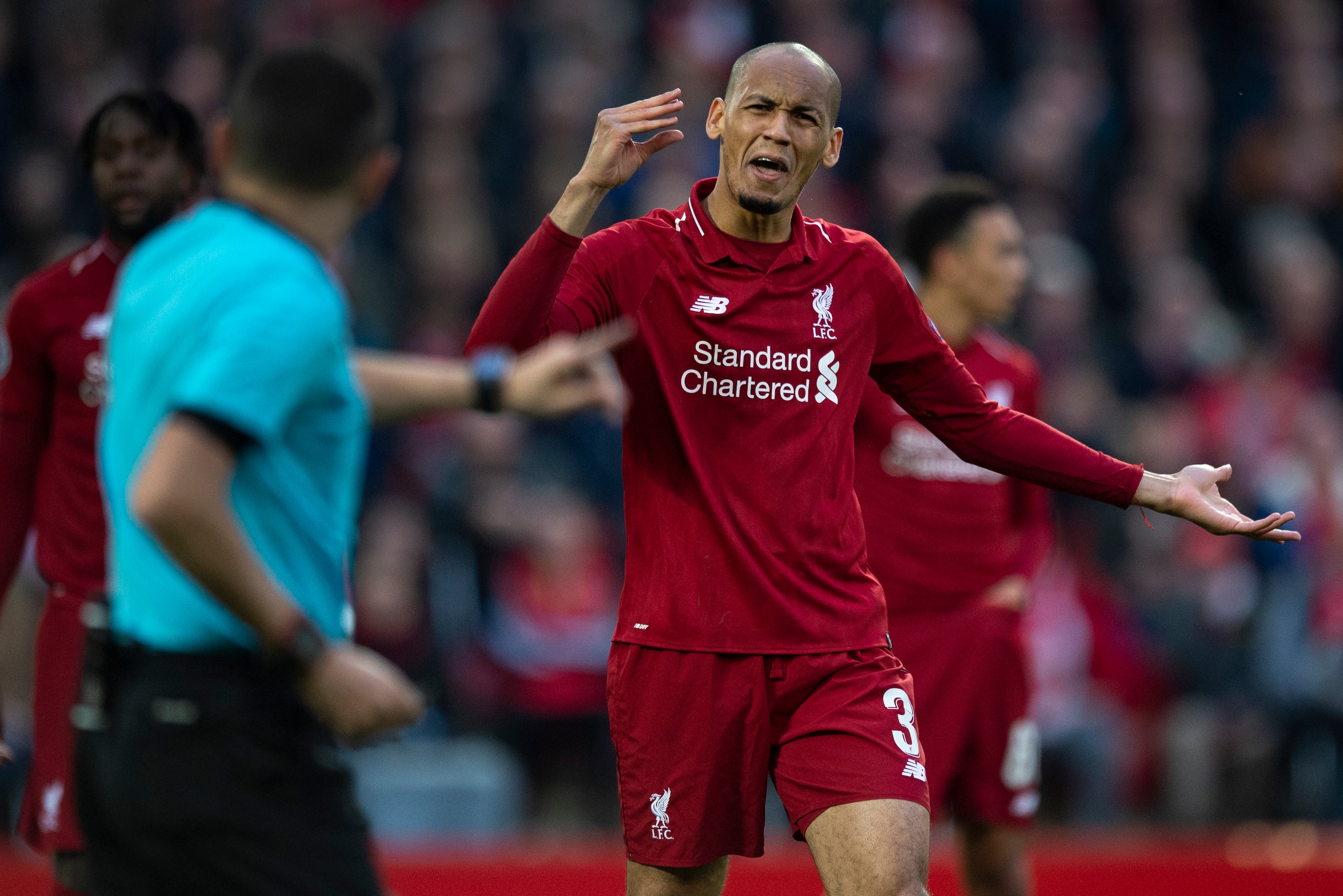 LIVERPOOL, ENGLAND - MAY 07: Fabinho of Liverpool argues with referee Cuneyt Cakir during the UEFA Champions League Semi Final second leg match between Liverpool and Barcelona at Anfield on May 7, 2019 in Liverpool, England. (Photo by Visionhaus/Getty Ima