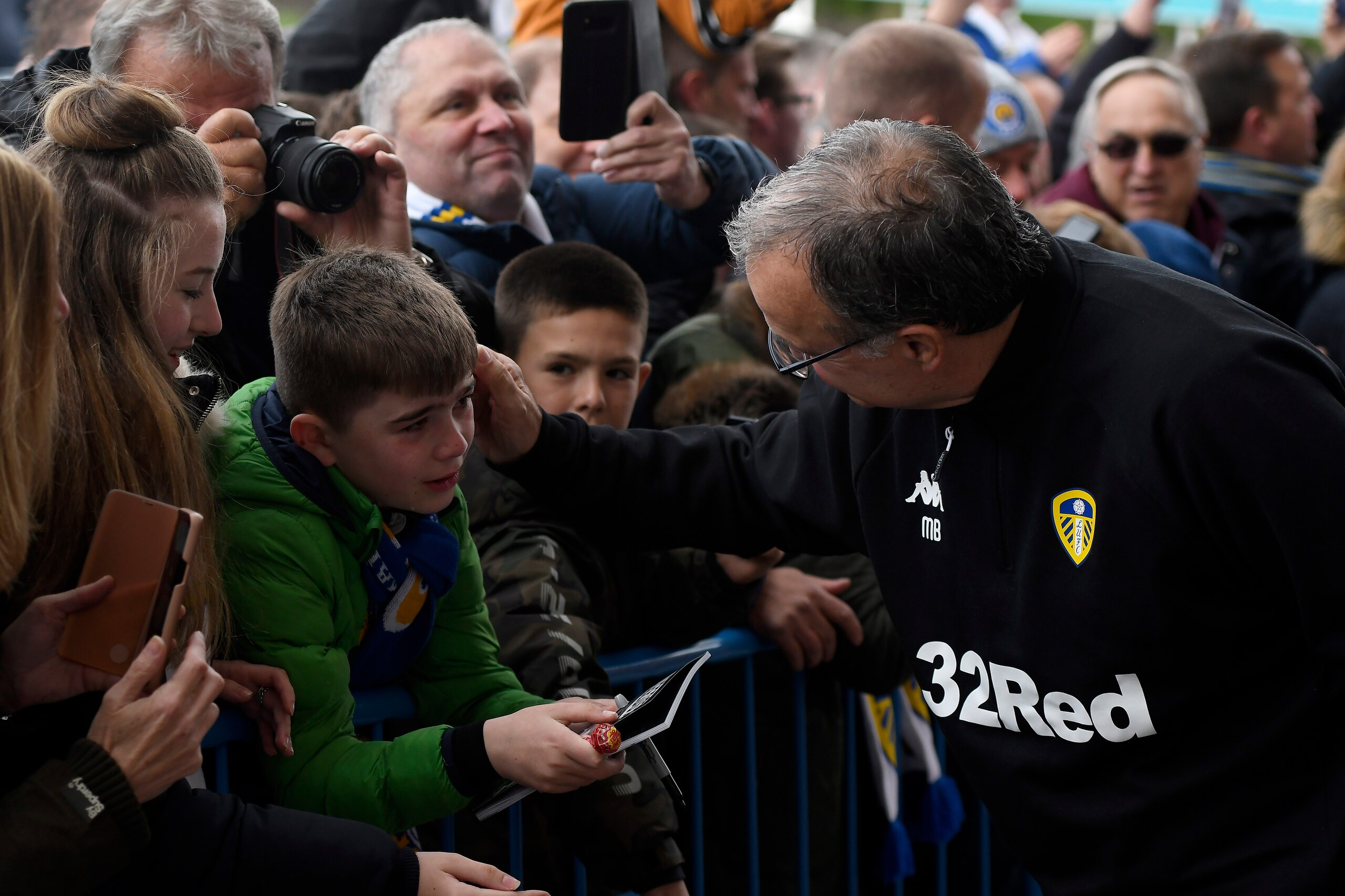 LEEDS, ENGLAND - APRIL 28: Manager of Leeds United Marcelo Bielsa consoles a young fan as he arrives at the stadium prior to the Sky Bet Championship match between Leeds United and Aston Villa at Elland Road on April 28, 2019 in Leeds, England. (Photo by 