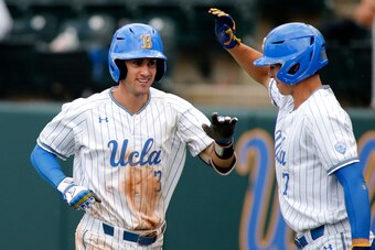 LOS ANGELES, CALIFORNIA - MAY 19:   Ryan Kreidler #3 of UCLA high-fives teammate Michael Toglia #7 following Kreidler's second home run during a baseball game against University of Washington at Jackie Robinson Stadium on May 19, 2019 in Los Angeles, Cali