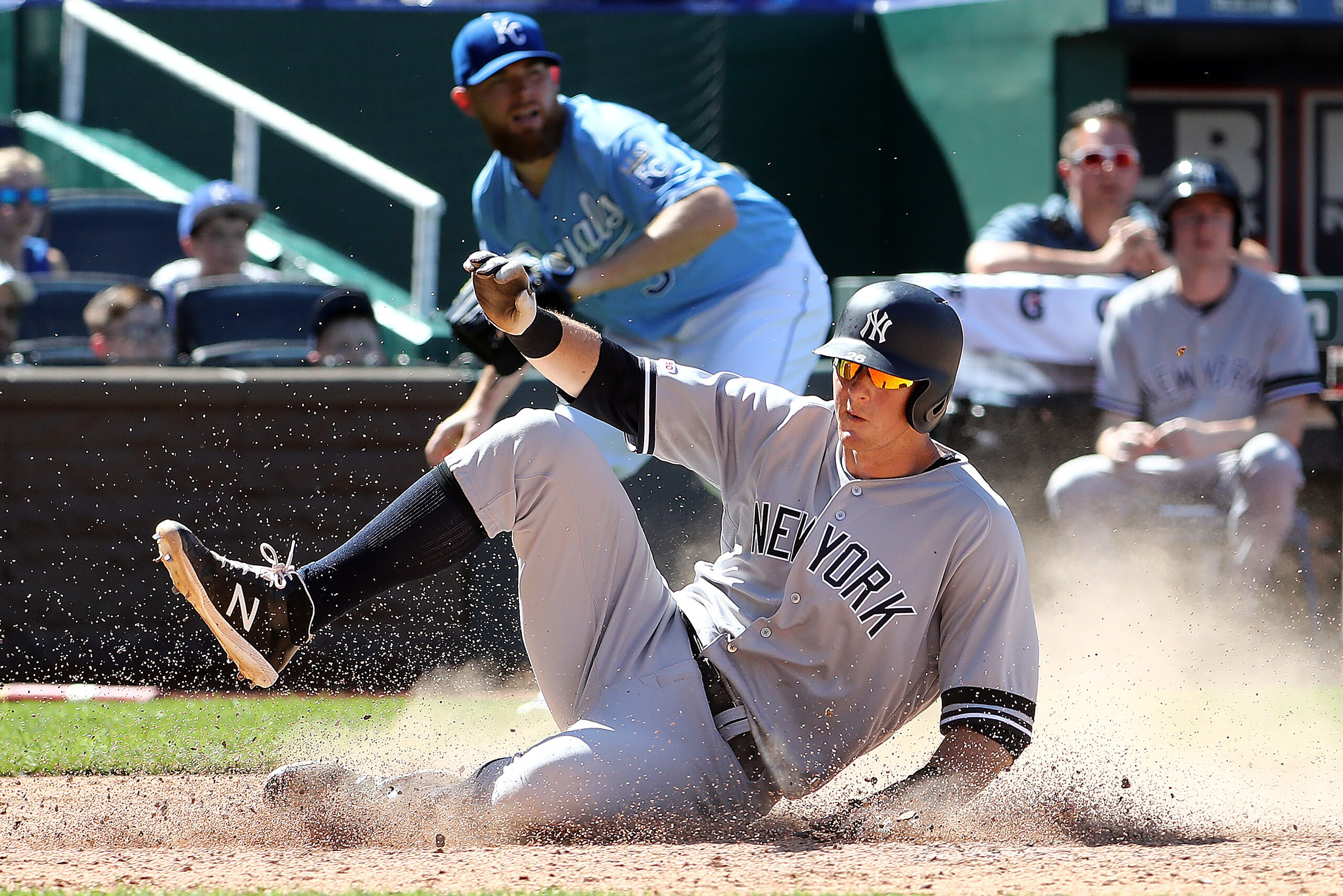 KANSAS CITY, MISSOURI - MAY 26:  DJ LeMahieu #26 of the New York Yankees slides safely into home plate to score and tie the game in the top of the 9th inning of the game against the Kansas City Royals at Kauffman Stadium on May 26, 2019 in Kansas City, Mi