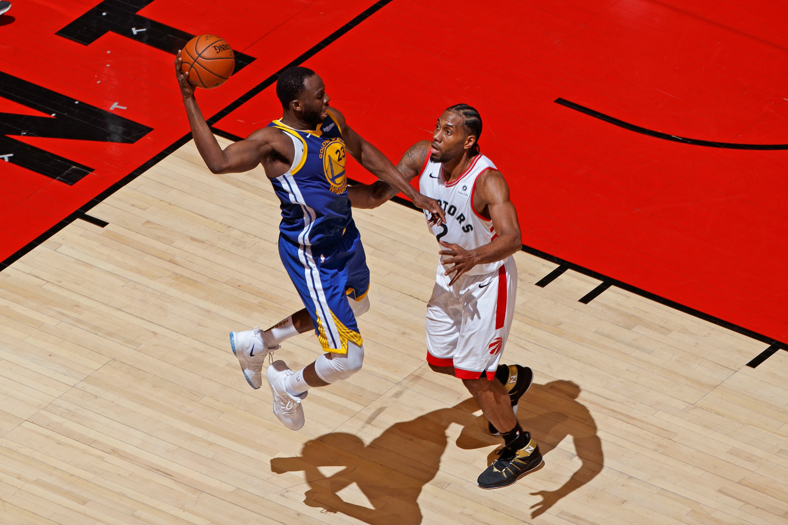 TORONTO, CANADA - MAY 30: Draymond Green #23 of the Golden State Warriors passes the ball while guarded by Kawhi Leonard #2 of the Toronto Raptors during Game One of the NBA Finals on May 30, 2019 at Scotiabank Arena in Toronto, Ontario, Canada. NOTE TO U
