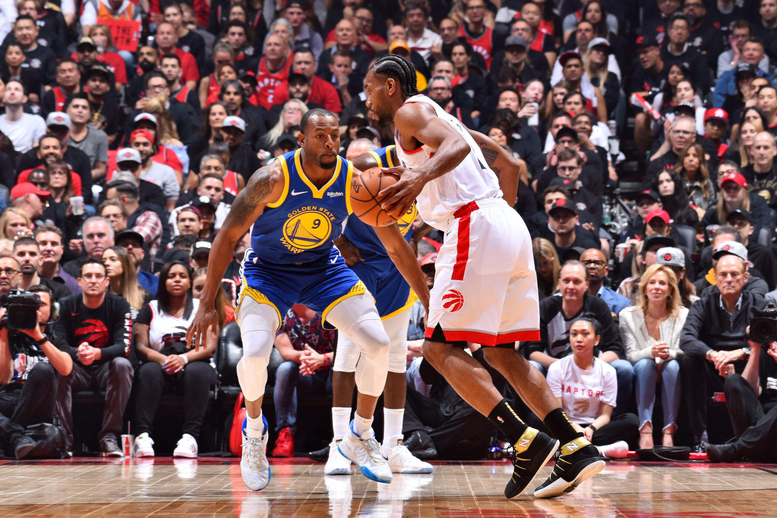 TORONTO, CANADA - MAY 30: Kawhi Leonard #2 of the Toronto Raptors handles the ball against Andre Iguodala #9 of the Golden State Warriors during Game One of the NBA Finals on May 30, 2019 at Scotiabank Arena in Toronto, Ontario, Canada. NOTE TO USER: User