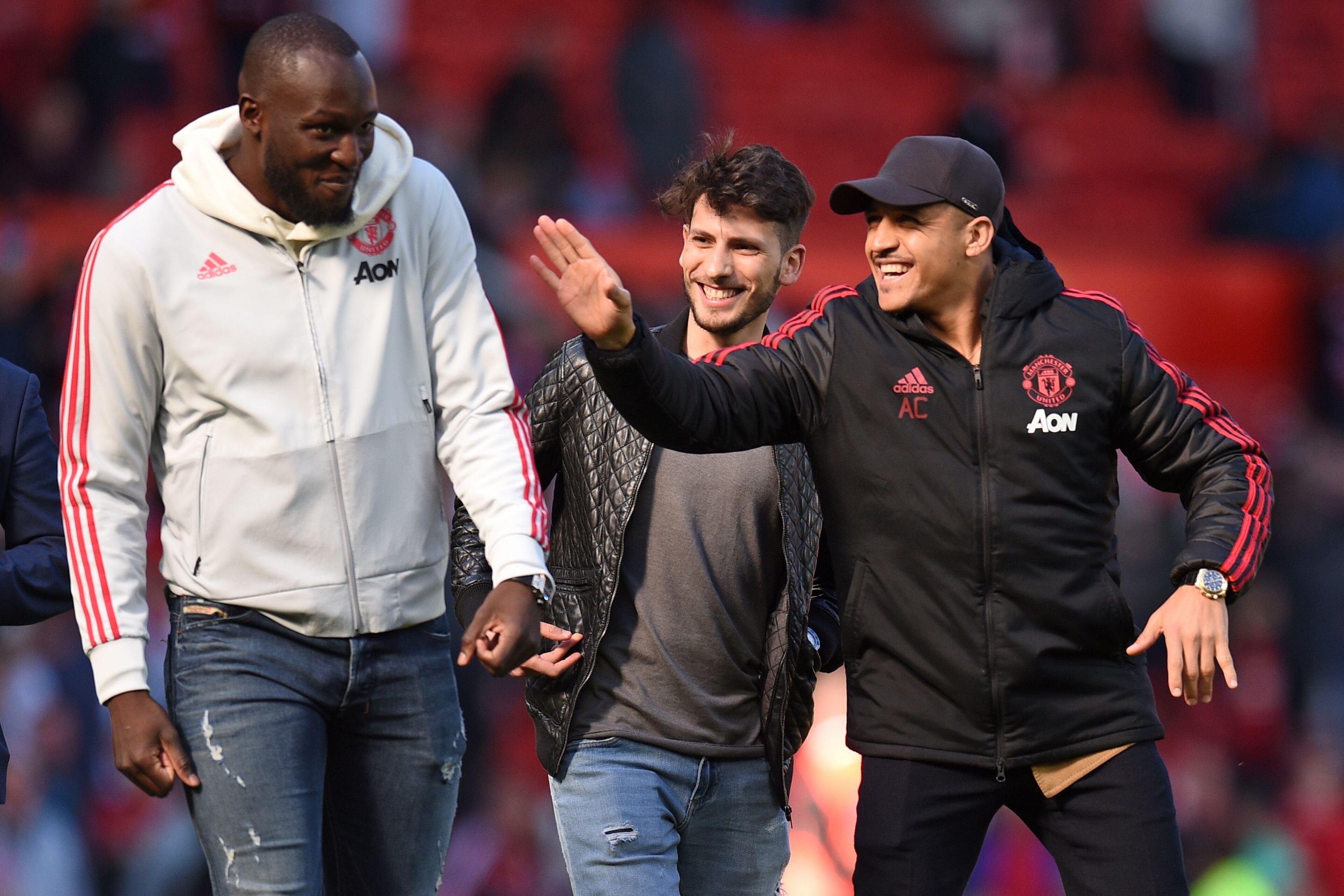 Manchester United's Chilean striker Alexis Sanchez (R) and Manchester United's Belgian striker Romelu Lukaku (L) share a joke on the pitch after the English Premier League football match between Manchester United and Cardiff City at Old Trafford in Manche