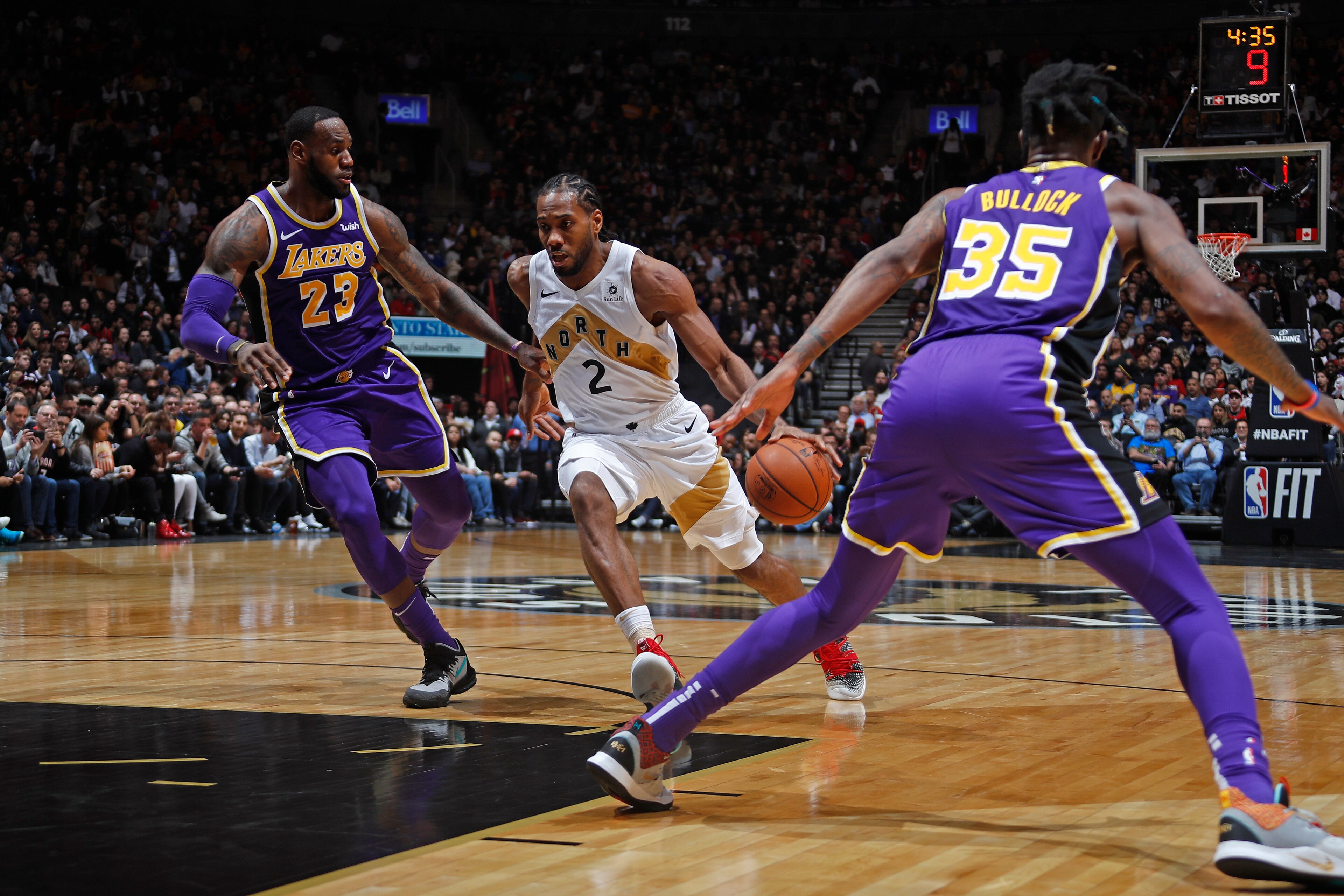 TORONTO, CANADA - MARCH 14: Kawhi Leonard #2 of the Toronto Raptors handles the ball against LeBron James #23 of the Los Angeles Lakers on March 14, 2019 at the Scotiabank Arena in Toronto, Ontario, Canada.  NOTE TO USER: User expressly acknowledges and a