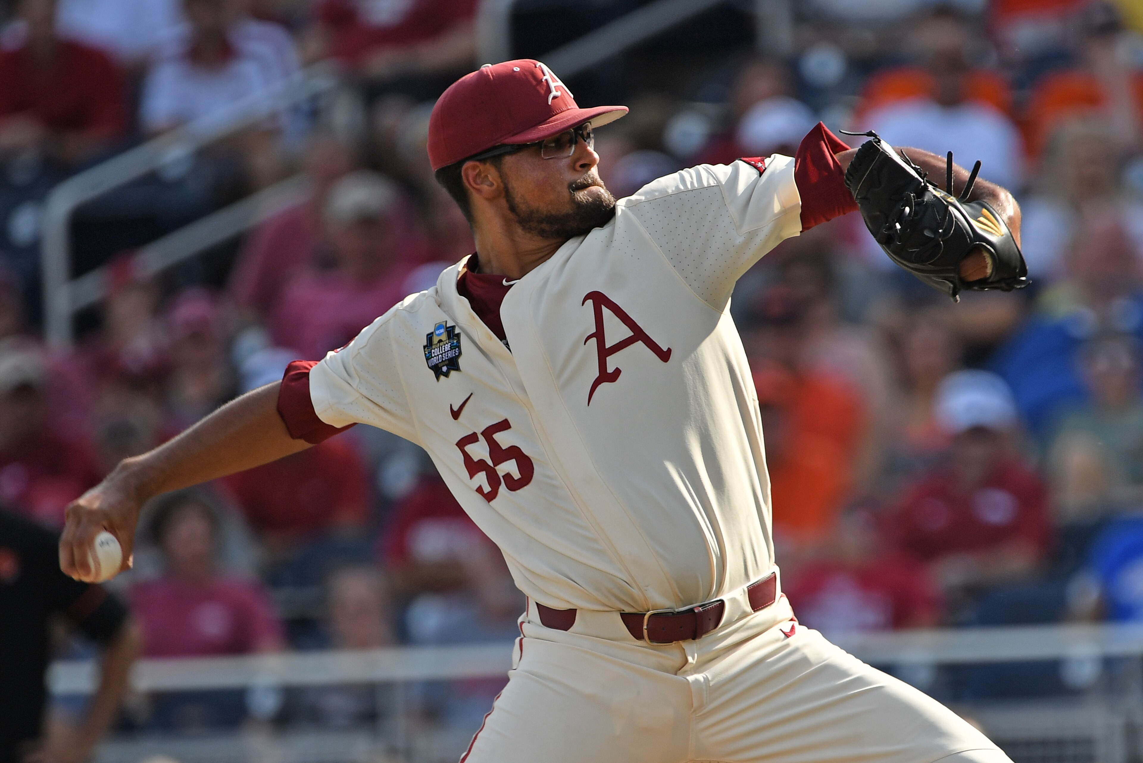 Omaha, NE - JUNE 28: Pitcher Isaiah Campbell #55 of the Arkansas Razorbacks delivers a pitch in the first inning against the Oregon State Beavers during game three of the College World Series Championship Series on June 28, 2018 at TD Ameritrade Park in Omaha, NE - JUNE 28: Pitcher Isaiah Campbell #55 of the Arkansas Razorbacks delivers a pitch in the first inning against the Oregon State Beavers during game three of the College World Series Championship Series on June 28, 2018 at TD Ameritrade Park in