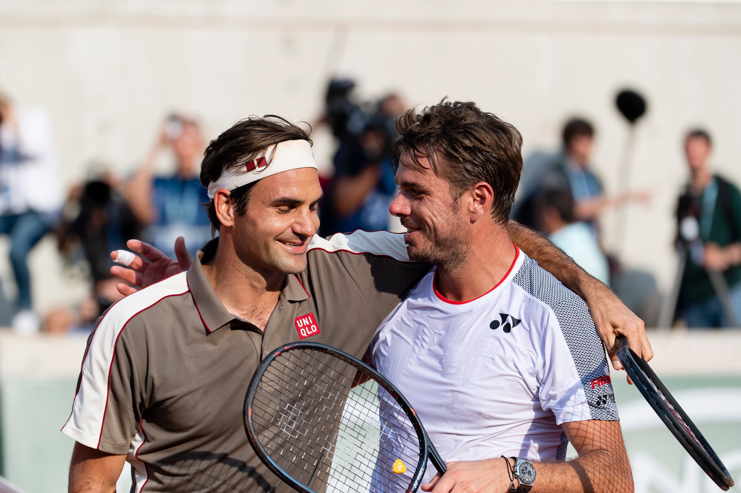 PARIS, FRANCE - JUNE 4: Roger Federer of Switzerland embraces Stan Wawrinka of Switzerland at the net after his quarter finals win on Day Ten at the French Open held at Roland Garros on June 4, 2019 in Paris, France (Photo by Peter Staples/ATP Tour)