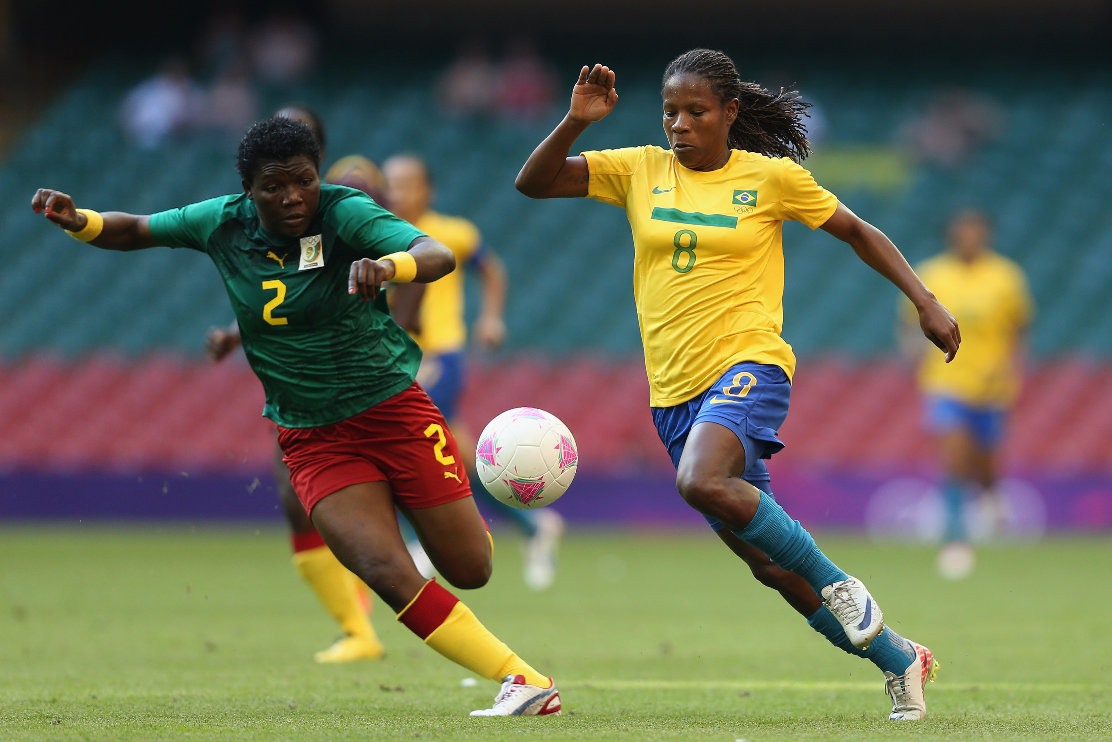 CARDIFF, WALES - JULY 25:  Formiga of Brazil
 in action with Christine Manie of Cameroon 
during the Women's Football first round Group E Match of the London 2012 Olympic Games between Cameroon and Brazil at Millennium Stadium on July 25, 2012 in Cardiff,