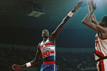 PORTLAND, OR - 1986: Manute Bol #10 of the Washington Bullets defends against the Portland Trail Blazers during a game played circa 1986 at the Veterans Memorial Coliseum in Portland, Oregon. NOTE TO USER: User expressly acknowledges and agrees that, by d