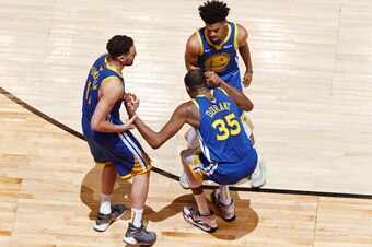 TORONTO, CANADA - JUNE 10: Klay Thompson #11 and Quinn Cook #4 help up Kevin Durant #35 of the Golden State Warriors after sustaining an injury during Game Five of the NBA Finals against the Toronto Raptors on June 10, 2019 at Scotiabank Arena in Toronto,
