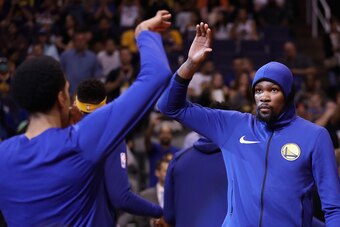 PHOENIX, AZ - APRIL 08:  Kevin Durant #35 (R) of the Golden State Warriors high fives Shaun Livingston #34 as he is introduced to the NBA game against the Phoenix Suns at Talking Stick Resort Arena on April 8, 2018 in Phoenix, Arizona. NOTE TO USER: User 