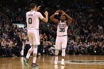 BOSTON, MA - MAY 13: Jayson Tatum #0 and Marcus Smart #36 of the Boston Celtics celebrate their teams lead over the Cleveland Cavaliers during the fourth quarter in Game One of the Eastern Conference Finals of the 2018 NBA Playoffs at TD Garden on May 13,