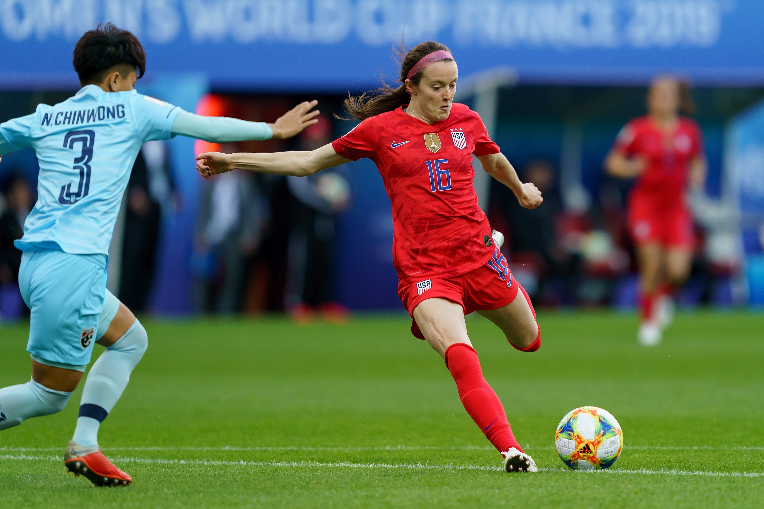REIMS, FRANCE - JUNE 11: Natthakarn Chinwong of Thailand and Rose Lavelle of USA battle for the ball during the 2019 FIFA Women's World Cup France group F match between USA and Thailand at Stade Auguste Delaune on June 11, 2019 in Reims, France. (Photo by