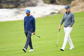 PEBBLE BEACH, CALIFORNIA - JUNE 14: Tiger Woods of the United States (L) and Jordan Spieth of the United States walk up the tenth hole during the second round of the 2019 U.S. Open at Pebble Beach Golf Links on June 14, 2019 in Pebble Beach, California. (