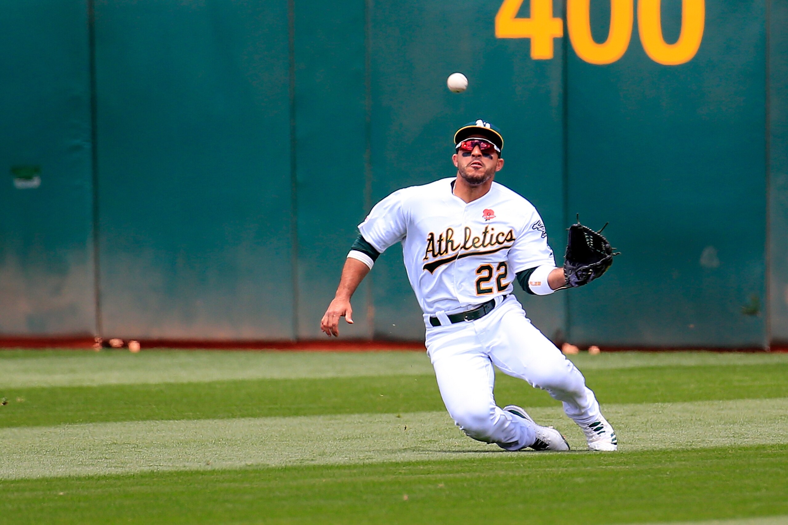 OAKLAND, CALIFORNIA - MAY 27: Ramon Laureano #22 of the Oakland Athletics makes a diving catch during the second inning against the Los Angeles Angels at Oakland-Alameda County Coliseum on May 27, 2019 in Oakland, California. (Photo by Daniel Shirey/Getty