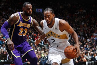 TORONTO, CANADA - MARCH 14: Kawhi Leonard #2 of the Toronto Raptors handles the ball against LeBron James #23 of the Los Angeles Lakers on March 14, 2019 at the Scotiabank Arena in Toronto, Ontario, Canada.  NOTE TO USER: User expressly acknowledges and a