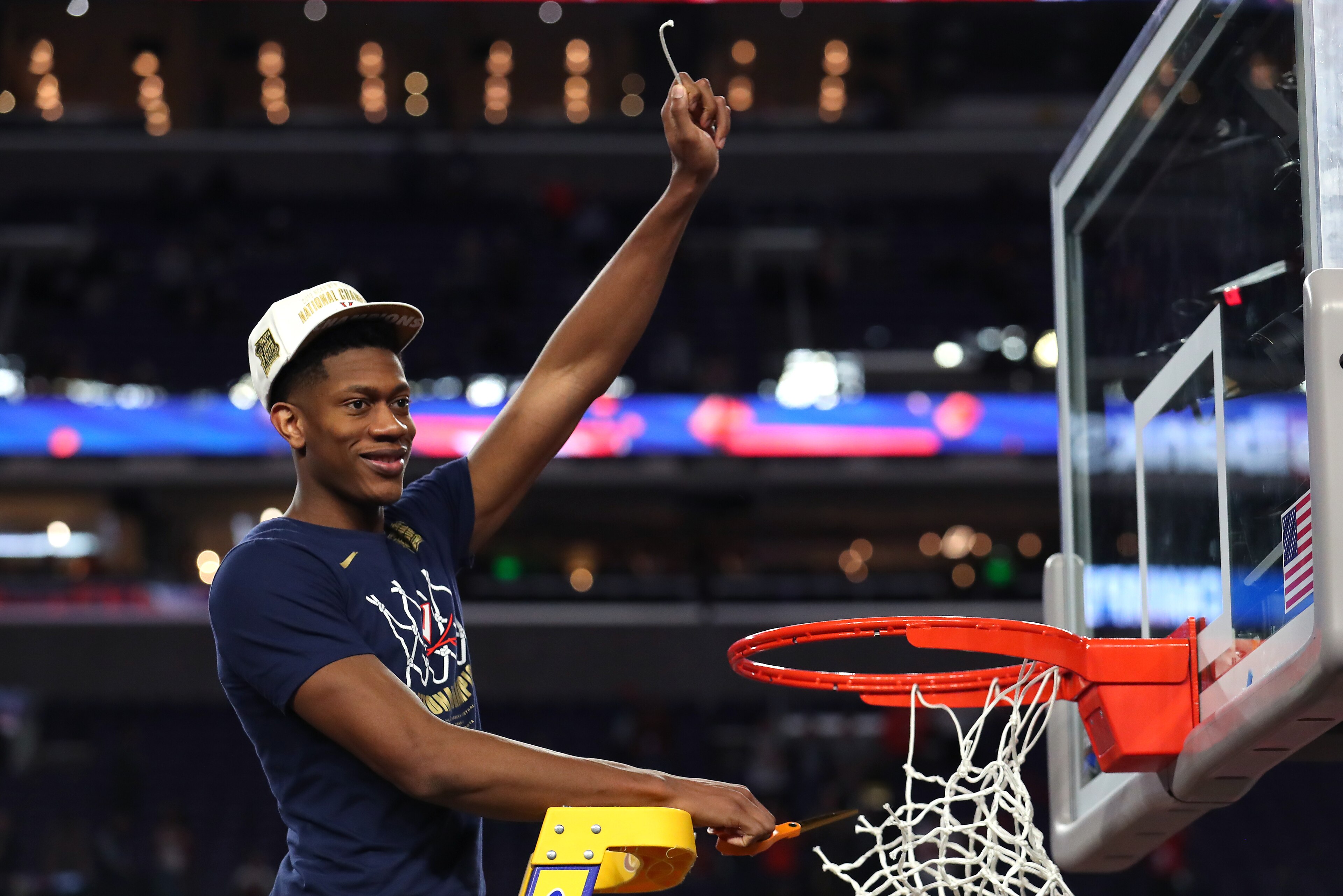 MINNEAPOLIS, MINNESOTA - APRIL 08:  De'Andre Hunter #12 of the Virginia Cavaliers cuts down the net after his teams 85-77 win over the Texas Tech Red Raiders in the 2019 NCAA men's Final Four National Championship game at U.S. Bank Stadium on April 08, 20