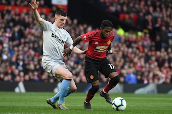 West Ham United's Irish defender Declan Rice (L) vies with Manchester United's Brazilian midfielder Fred during the English Premier League football match between Manchester United and West Ham United at Old Trafford in Manchester, north west England, on A