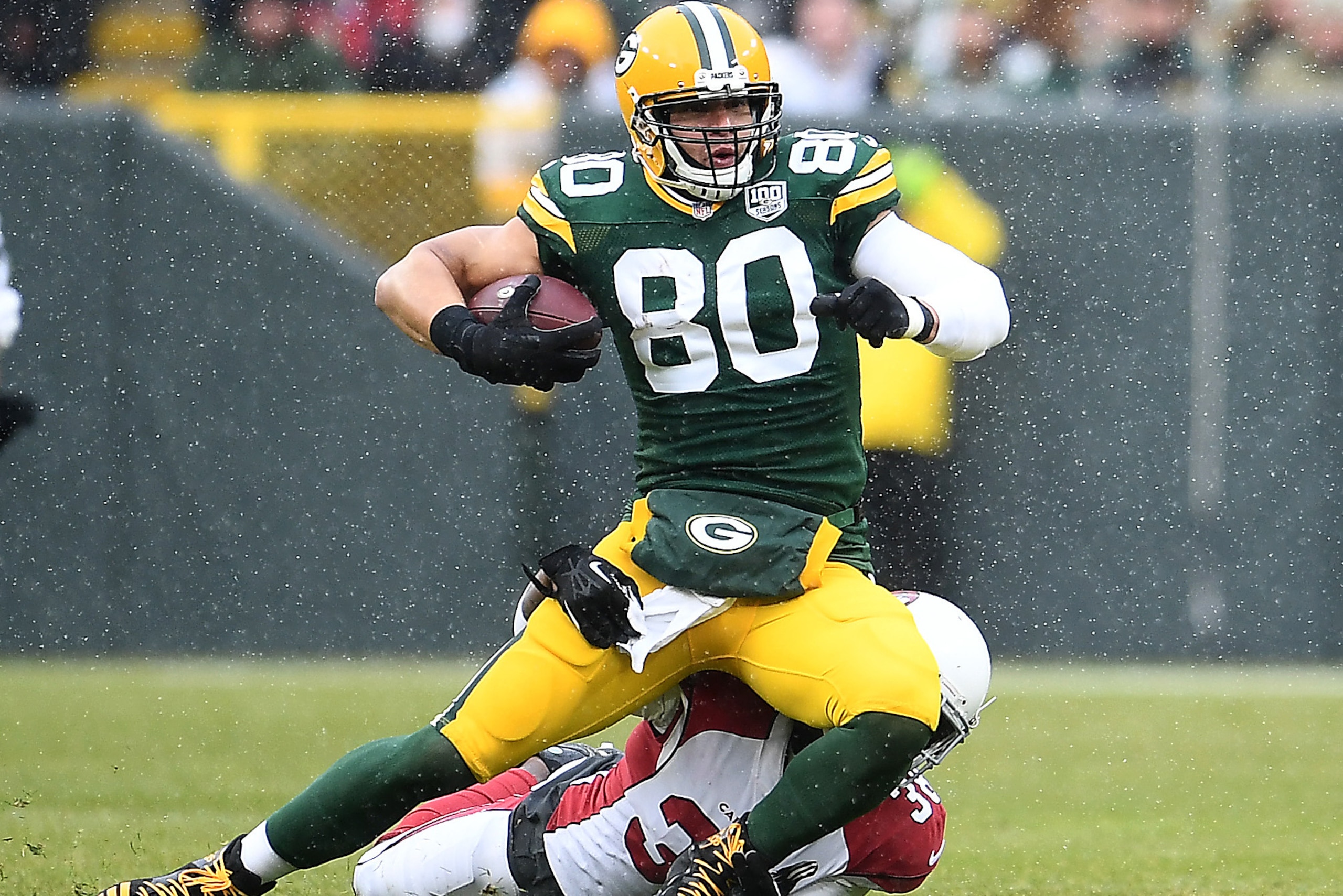 GREEN BAY, WISCONSIN - DECEMBER 02: Jimmy Graham #80 of the Green Bay Packers is tackled by David Amerson #38 of the Arizona Cardinals during the second half of a game at Lambeau Field on December 02, 2018 in Green Bay, Wisconsin. (Photo by Stacy Revere/G