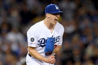 LOS ANGELES, CALIFORNIA - JUNE 21:  Walker Buehler #21 of the Los Angeles Dodgers celebrates a strikeout of Nolan Arenado #28 of the Colorado Rockies to end the top of the ninth inning at Dodger Stadium on June 21, 2019 in Los Angeles, California. (Photo 