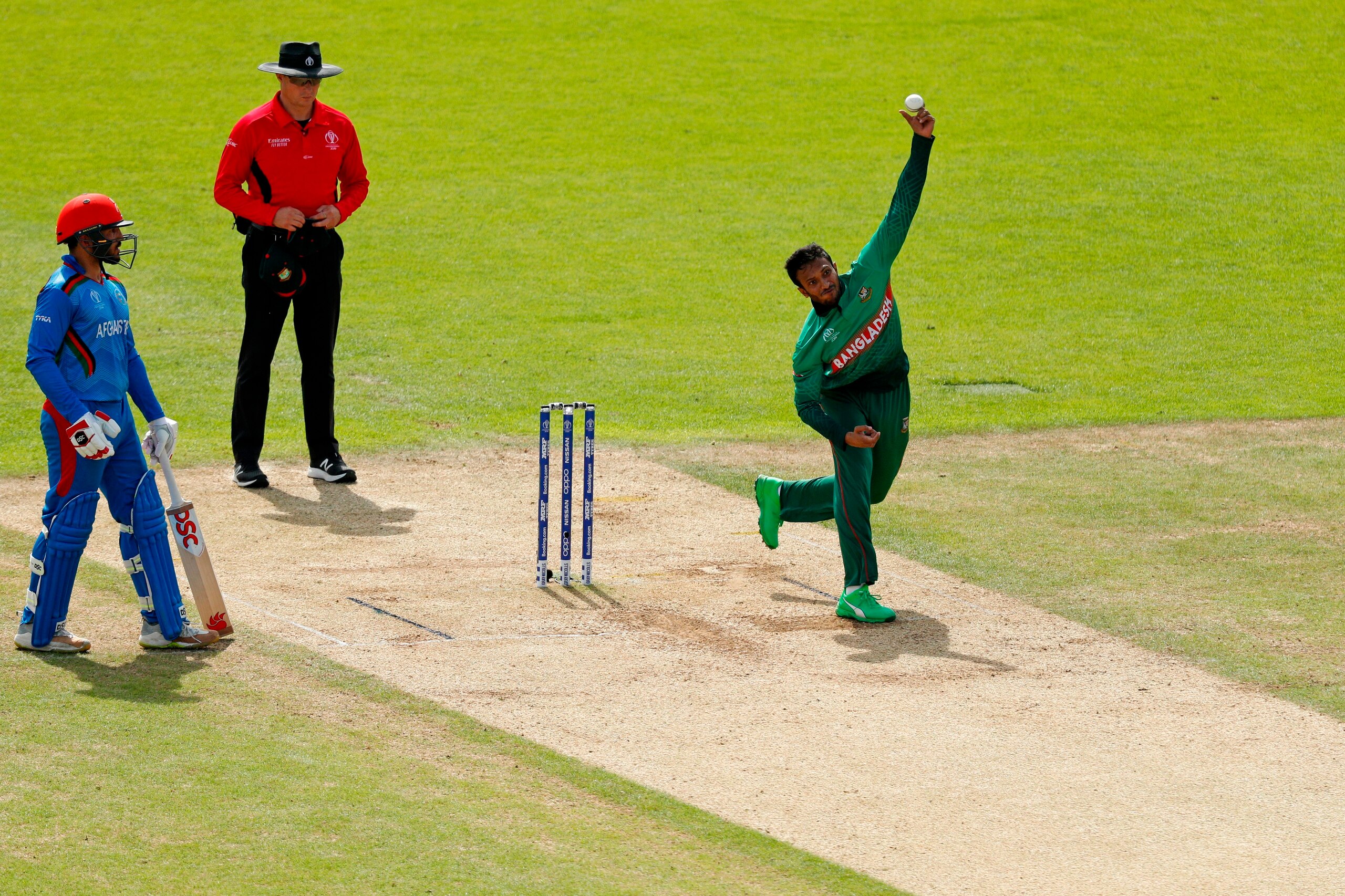 Bangladesh's Shakib Al Hasan (R) bowls the ball to take the wicket of Afghanistan's Rahmat Shah (unseen) for 24 runs during the 2019 Cricket World Cup group stage match between Bangladesh and Afghanistan at the Rose Bowl in Southampton, southern England, 