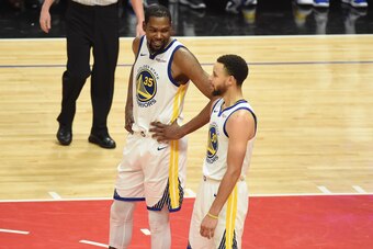 LOS ANGELES, CA - APRIL 26: Kevin Durant #35, and Stephen Curry #30 of the Golden State Warriors talk against the LA Clippers during Game Six of Round One of the 2019 NBA Playoffs on April 26, 2019 at STAPLES Center in Los Angeles, California. NOTE TO USE