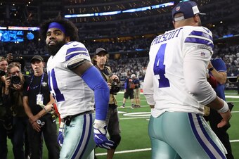 ARLINGTON, TEXAS - JANUARY 05:   Ezekiel Elliott #21 and Dak Prescott #4 of the Dallas Cowboys a win against the Seahawks 24-22 in the Wild Card Round at AT&T Stadium on January 05, 2019 in Arlington, Texas. (Photo by Ronald Martinez/Getty Images)