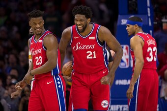 PHILADELPHIA, PA - FEBRUARY 08: Joel Embiid #21 and Jimmy Butler #23 of the Philadelphia 76ers laugh as Tobias Harris #33 looks on against the Denver Nuggets at the Wells Fargo Center on February 8, 2019 in Philadelphia, Pennsylvania. The 76ers defeated t