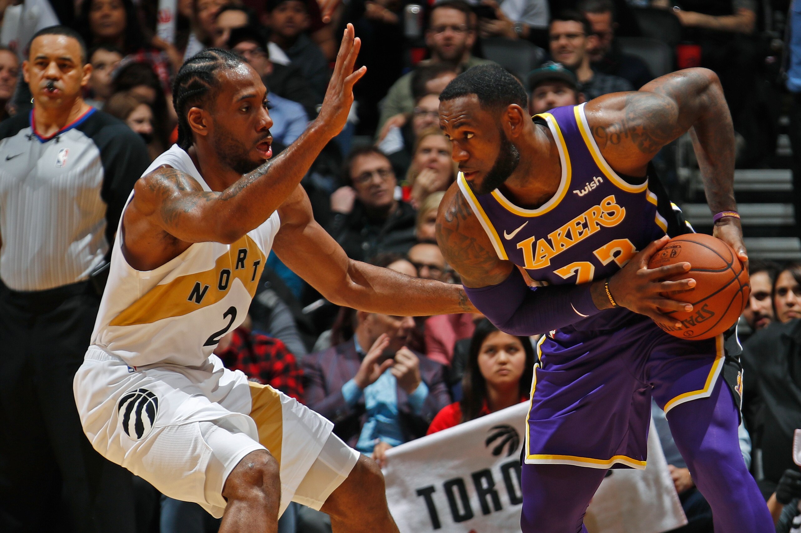 TORONTO, CANADA - MARCH 14: LeBron James #23 of the Los Angeles Lakers handles the ball against Kawhi Leonard #2 of the Toronto Raptors on March 14, 2019 at the Scotiabank Arena in Toronto, Ontario, Canada.  NOTE TO USER: User expressly acknowledges and a