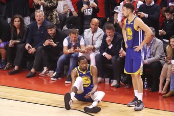 TORONTO, ONTARIO - JUNE 10:  Kevin Durant #35 of the Golden State Warriors reacts after sustaining an injury during the second quarter against the Toronto Raptors during Game Five of the 2019 NBA Finals at Scotiabank Arena on June 10, 2019 in Toronto, Can