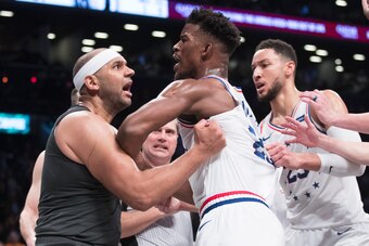 Jimmy Butler tangled up with Nets veteran Jared Dudley.