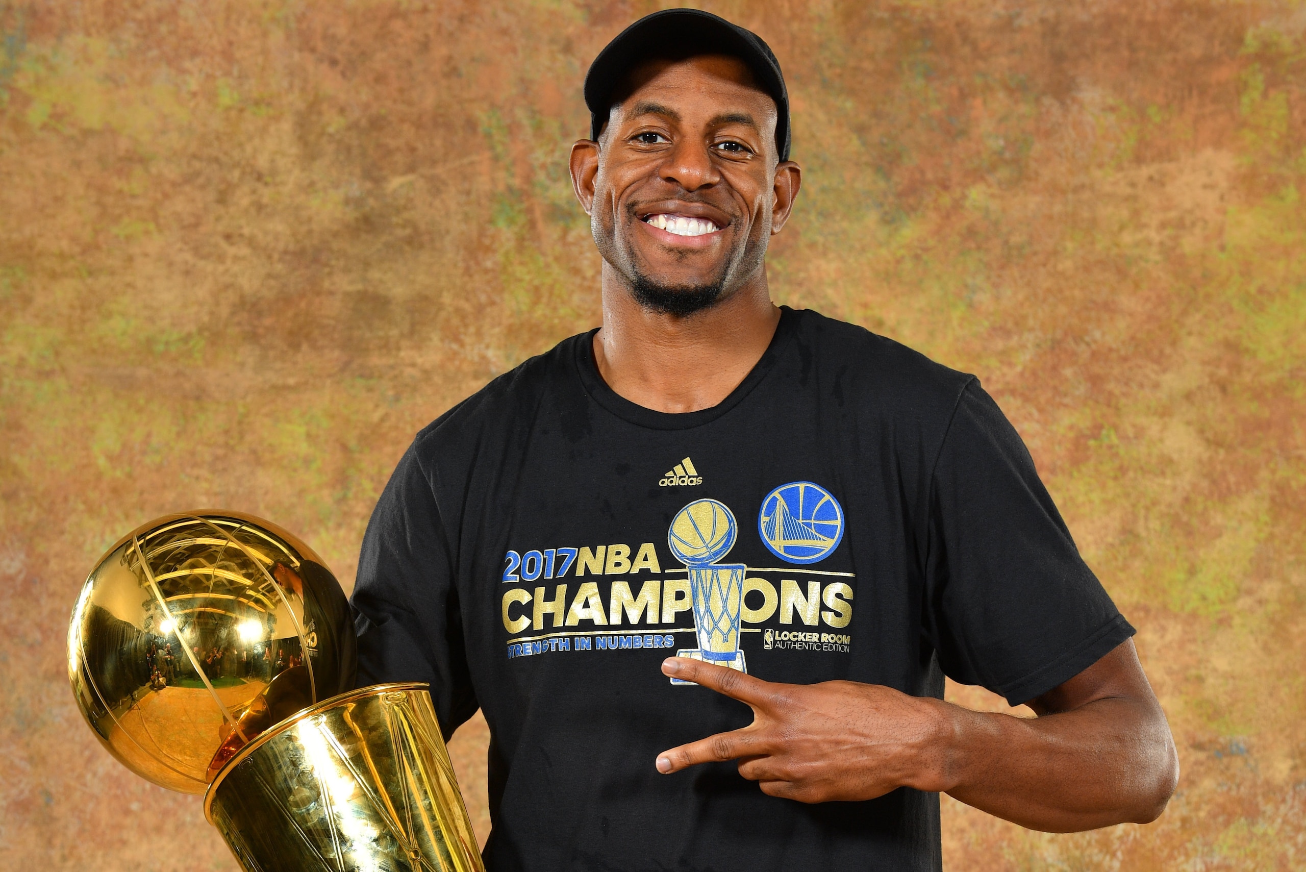 OAKLAND, CA - JUNE 12: Andre Iguodala of the Golden State Warriors poses for a portrait with the Larry O'Brien Trophy after defeating the Cleveland Cavaliers in Game Five of the 2017 NBA Finals on June 12, 2017 at ORACLE Arena in Oakland, California. NOTE