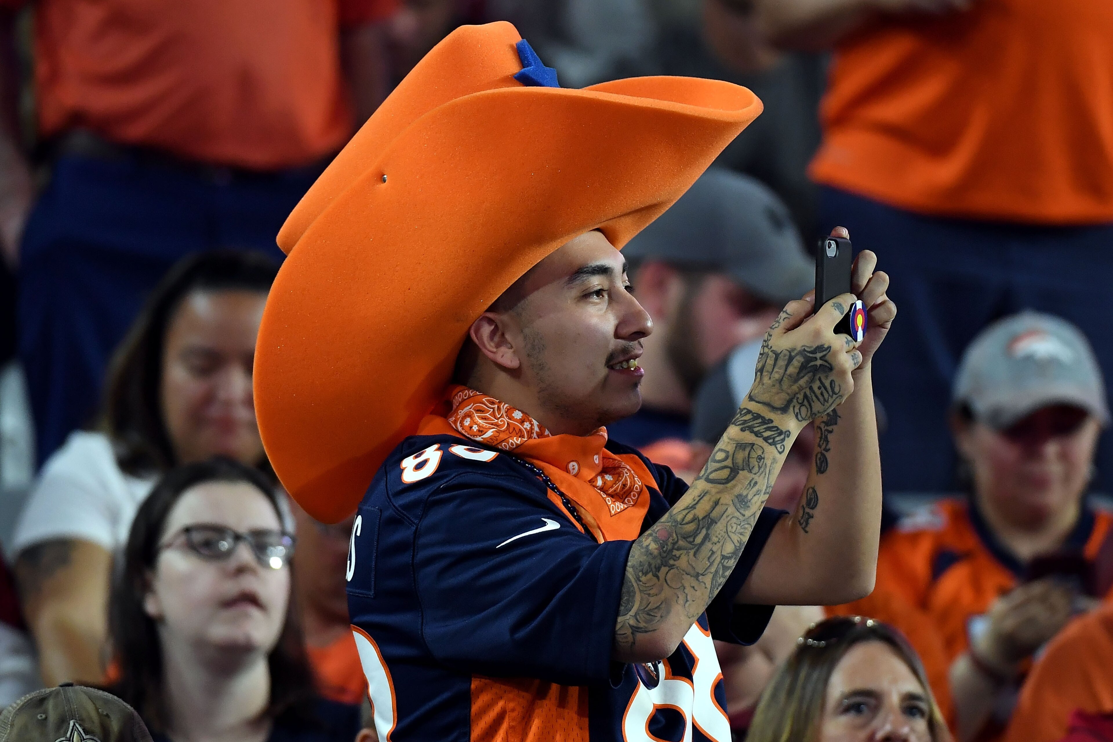 GLENDALE, AZ - OCTOBER 18: A Denver Broncos fan takes a photo during the second half against the Arizona Cardinals at State Farm Stadium on October 18, 2018 in Glendale, Arizona. (Photo by Norm Hall/Getty Images)