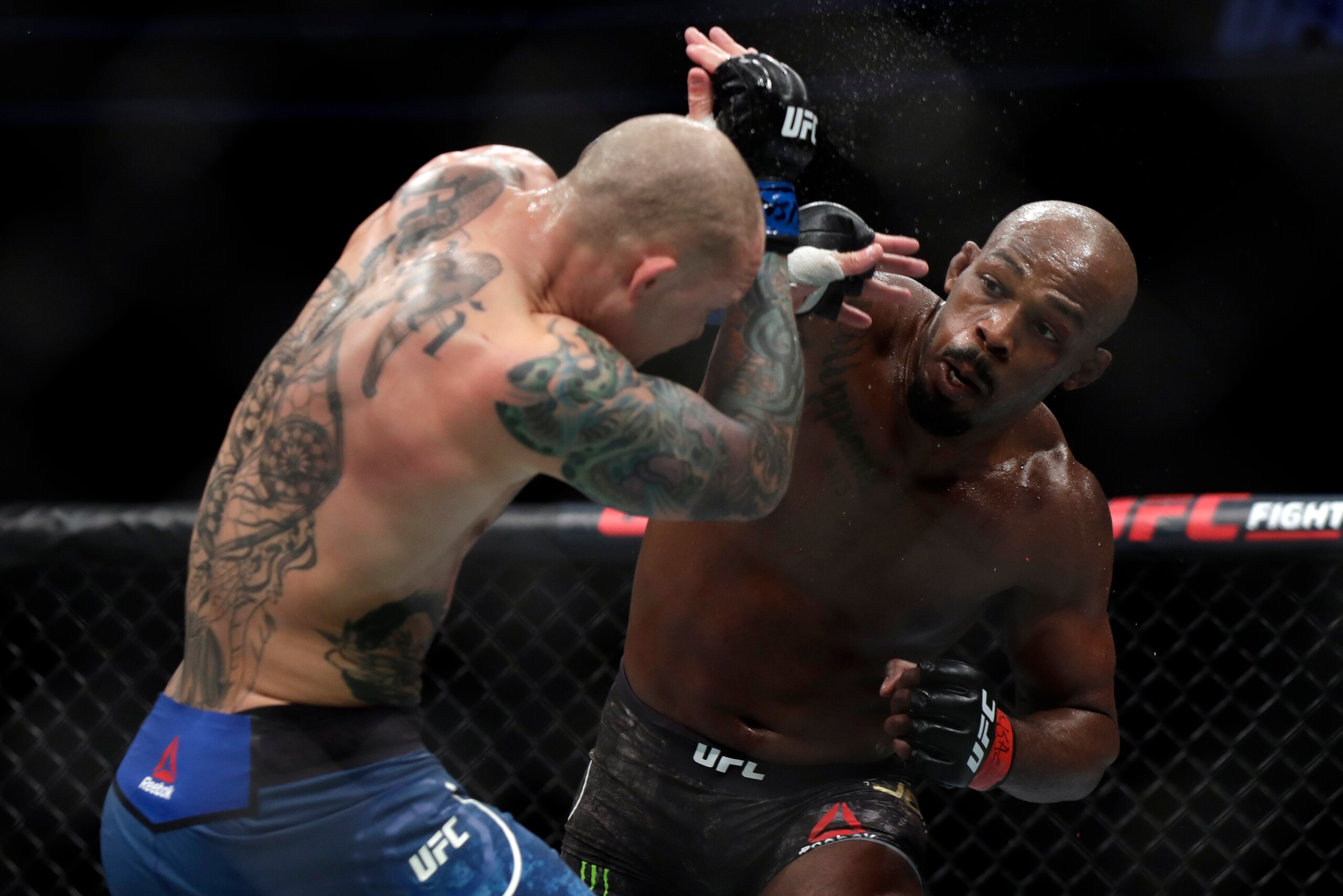 LAS VEGAS, NEVADA - MARCH 02: Jon Jones (R) and Anthony Smith trade punches during their light heavyweight title bout during UFC 235 at T-Mobile Arena on March 02, 2019 in Las Vegas, Nevada. Jones won by unanimous decision.  (Photo by Isaac Brekken/Getty 