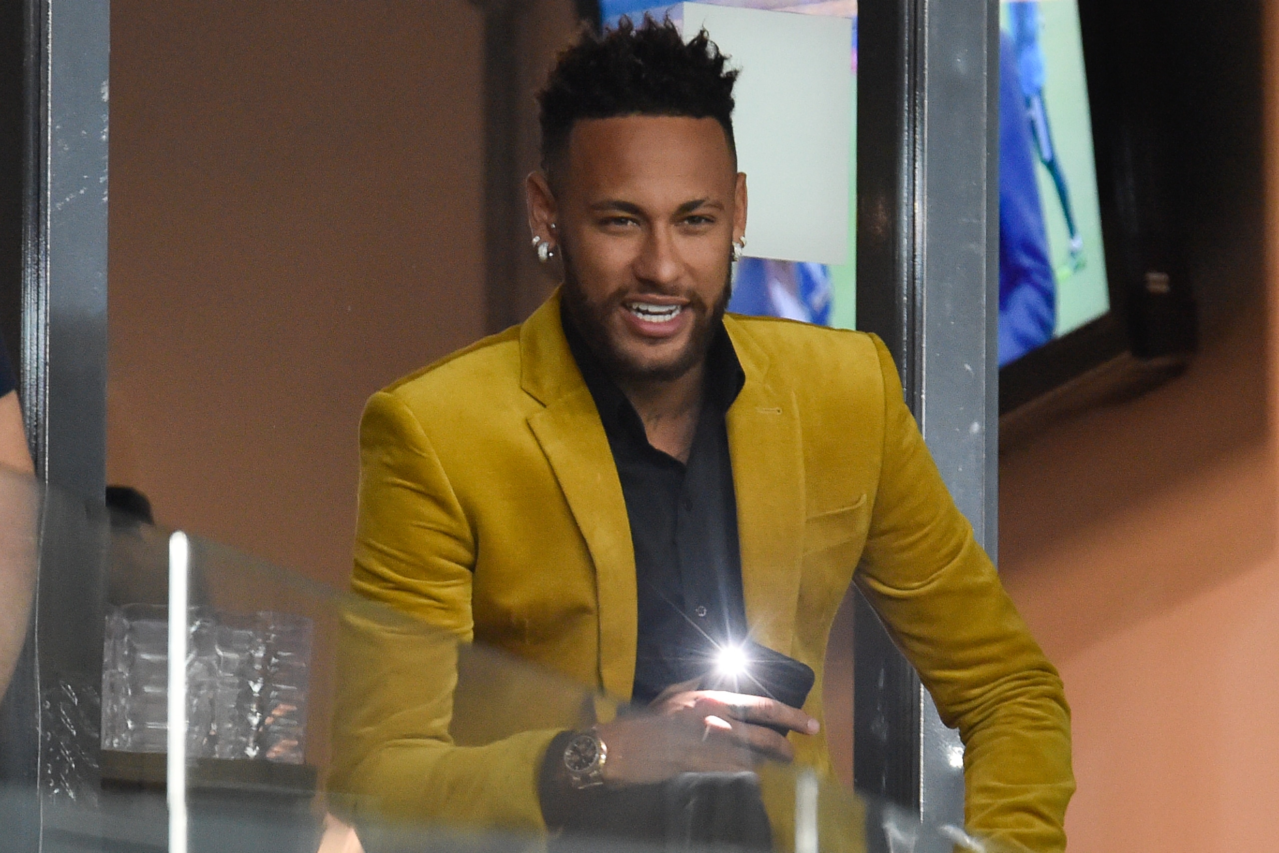 Brazil's injured football star Neymar is seen at the VIP area before the Copa America football tournament semi-final match between Brazil and Argentina at the Mineirao Stadium in Belo Horizonte, Brazil, on July 2, 2019. (Photo by Douglas Magno / AFP)     