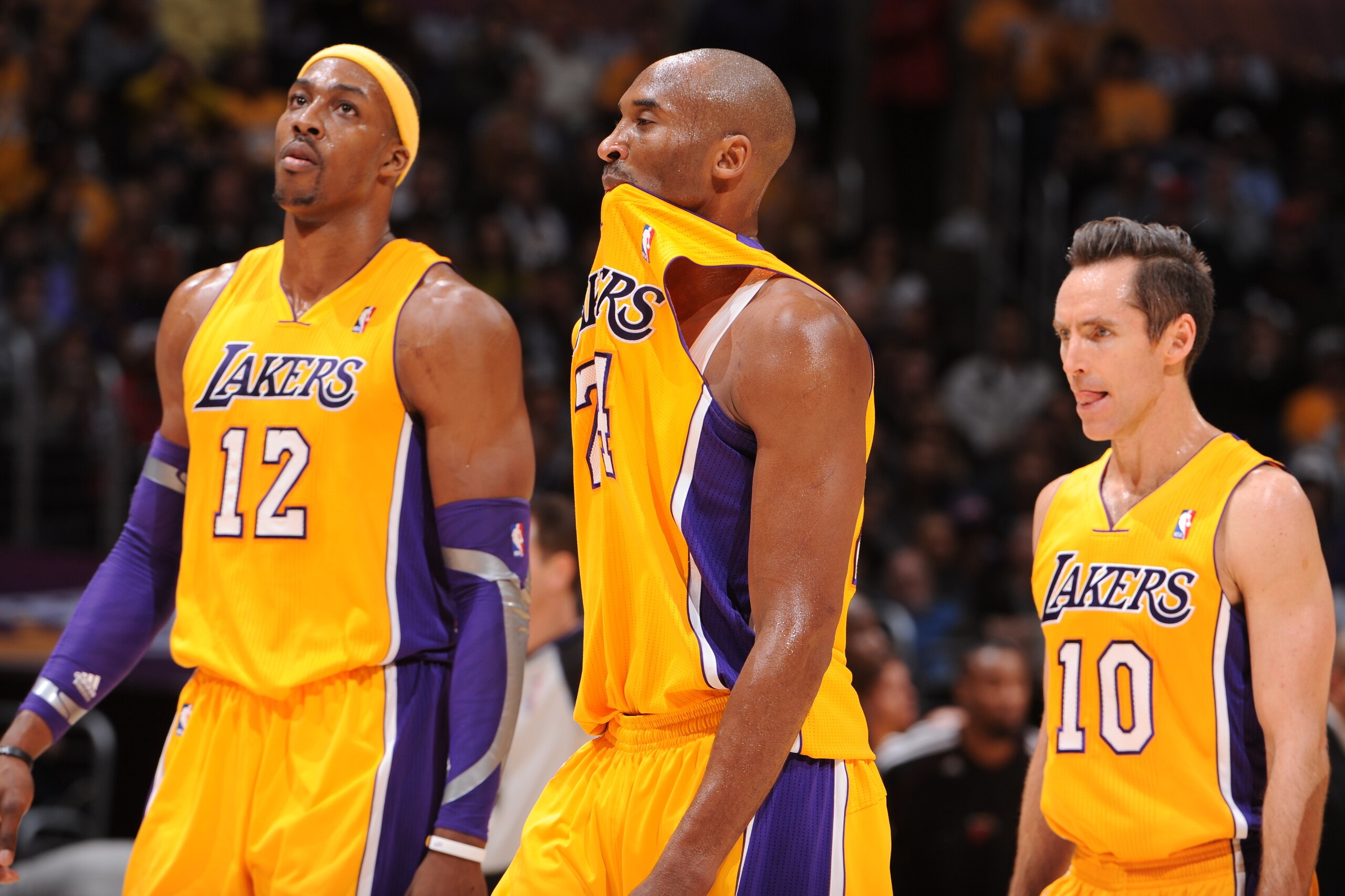 LOS ANGELES, CA - JANUARY 17: Dwight Howard #12, Kobe Bryant #24, and Steve Nash #10 of the Los Angeles Lakers walk toward the bench against the Miami Heat at Staples Center on January 15, 2013 in Los Angeles, California. NOTE TO USER: User expressly ackn