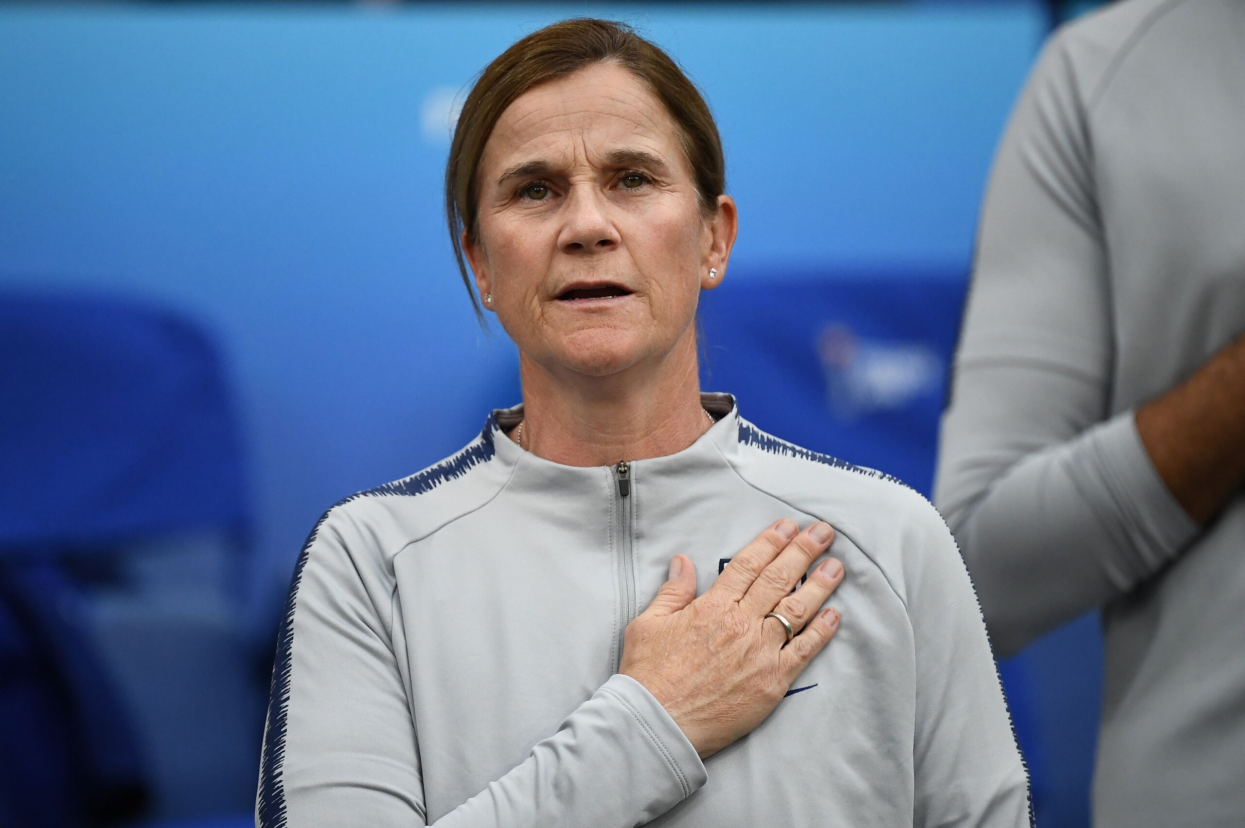 United States' coach Jillian Ellis stands for the anthem before the France 2019 Women's World Cup semi-final football match between England and USA, on July 2, 2019, at the Lyon Satdium in Decines-Charpieu, central-eastern France. (Photo by FRANCK FIFE / 