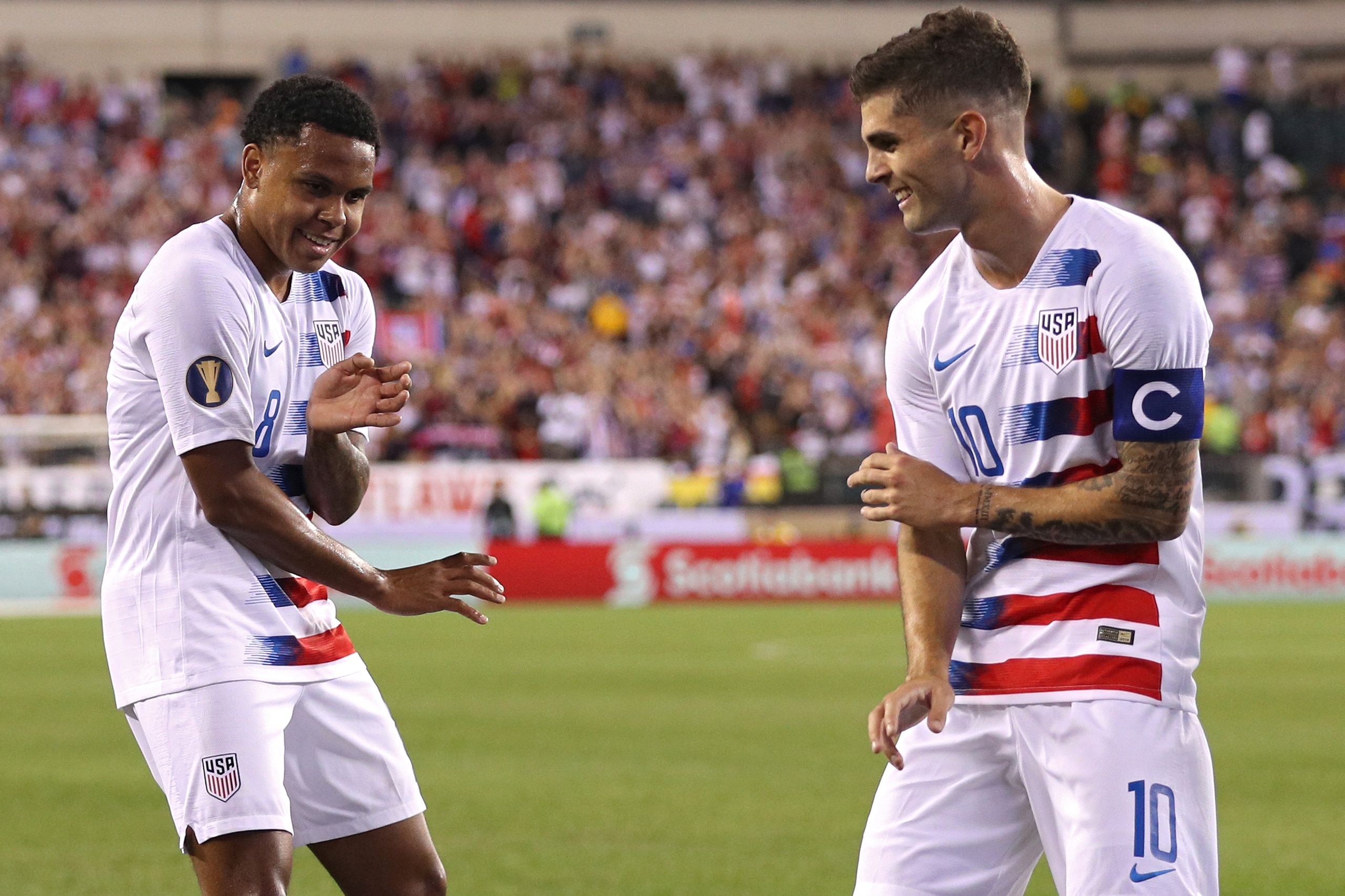 PHILADELPHIA, PENNSYLVANIA - JUNE 30: Weston Mckennie #8 of the United States (L) celebrates his goal with teammate Christian Pulisic #10 against Curacao during the first half of the CONCACAF Gold Cup Quarterfinals match at Lincoln Financial Field on June