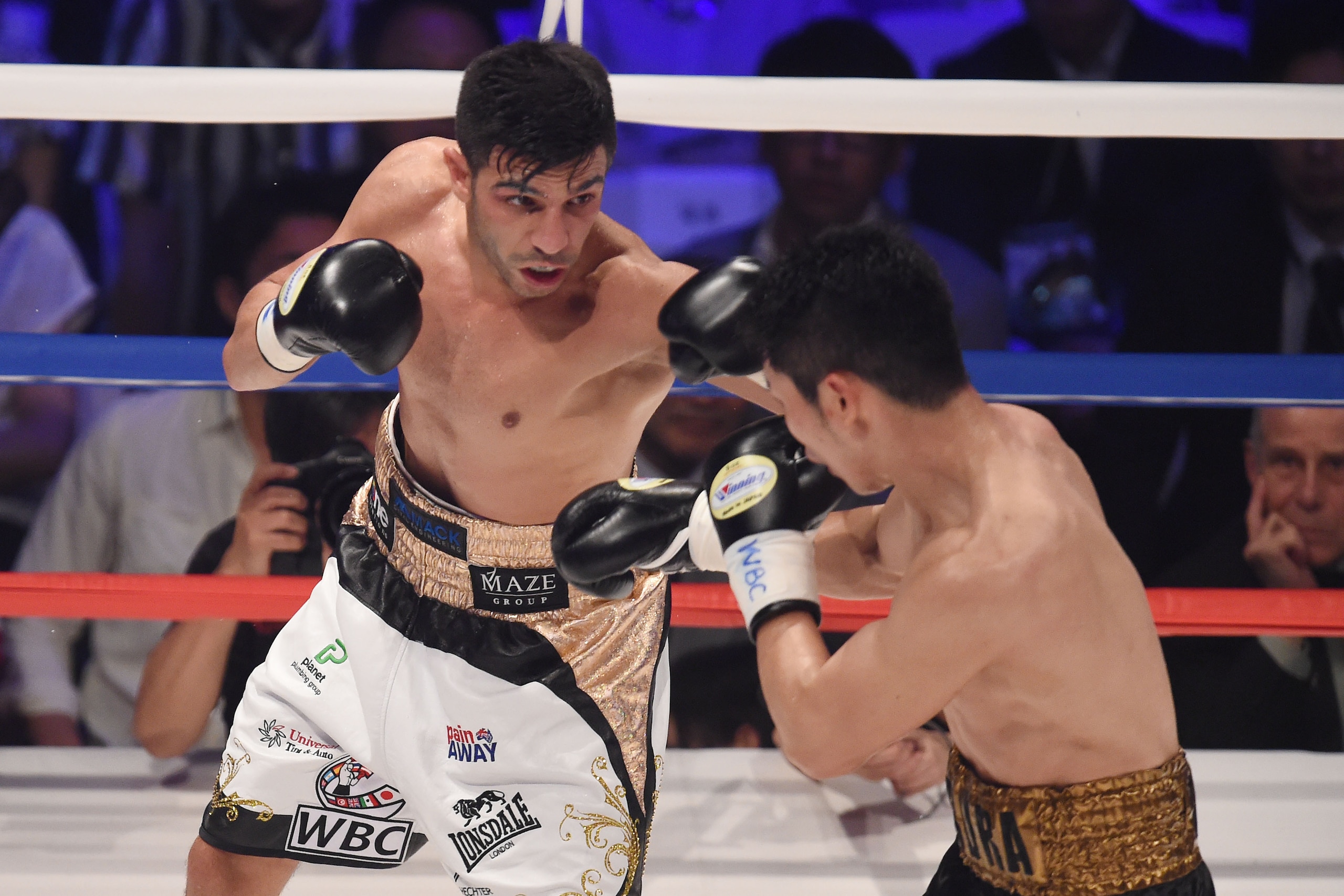 TOKYO, JAPAN - MAY 01:  Takashi Miura of Japan (R) and Billy Dib (L) of Australia exchange puches duing the WBC world super featherweight title bout between Takashi Miura of Japan and Billy Dib of Australia at the Ota-City General Gymnasium on May 1, 2015
