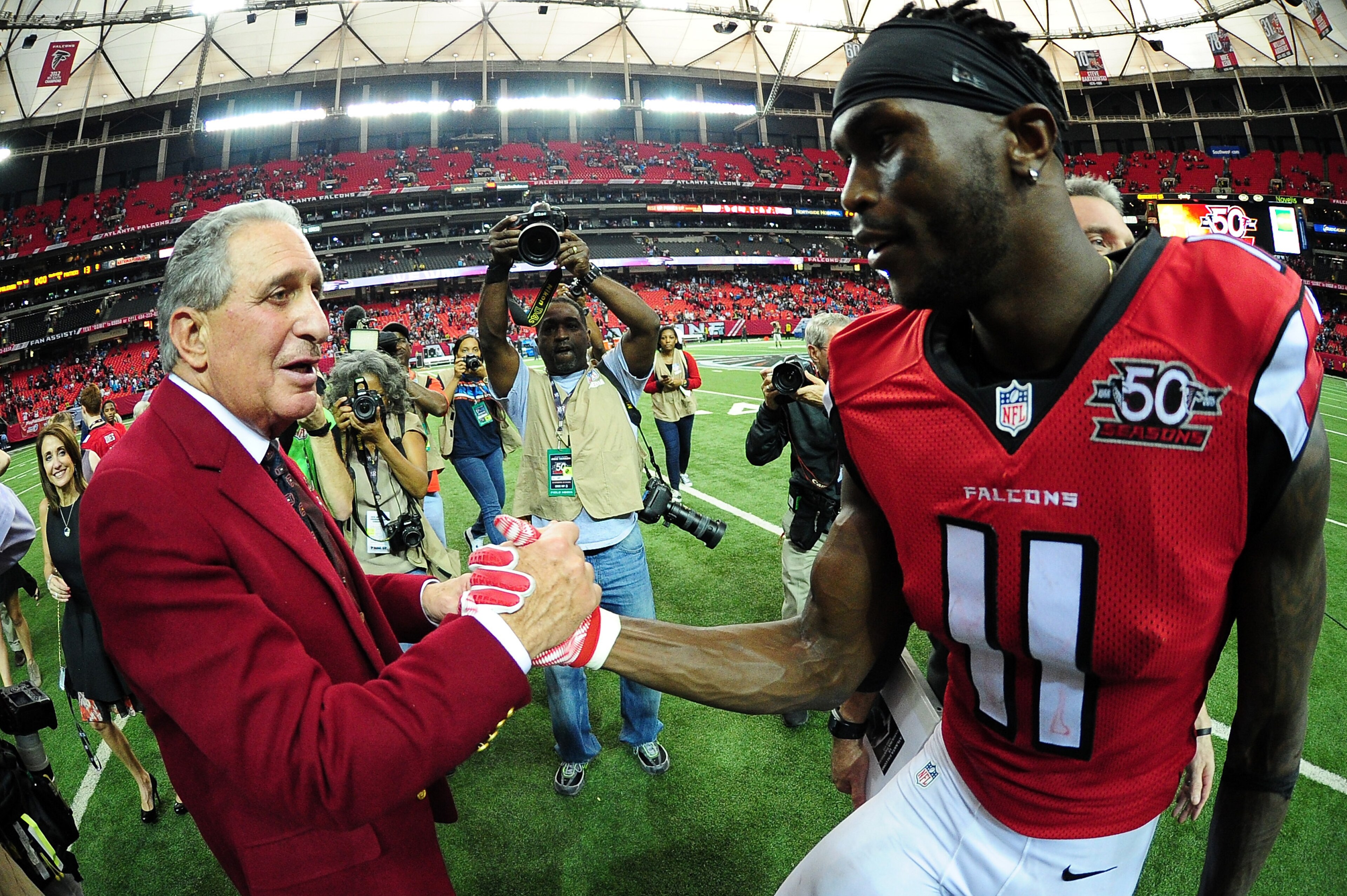 ATLANTA, GA - DECEMBER 27: Julio Jones #11 of the Atlanta Falcons shakes hands with team owner Arthur Blank after beating the Carolina Panthers at the Georgia Dome on December 27, 2015 in Atlanta, Georgia. (Photo by Scott Cunningham/Getty Images) ATLANTA, GA - DECEMBER 27: Julio Jones #11 of the Atlanta Falcons shakes hands with team owner Arthur Blank after beating the Carolina Panthers at the Georgia Dome on December 27, 2015 in Atlanta, Georgia. (Photo by Scott Cunningham/Getty Images)