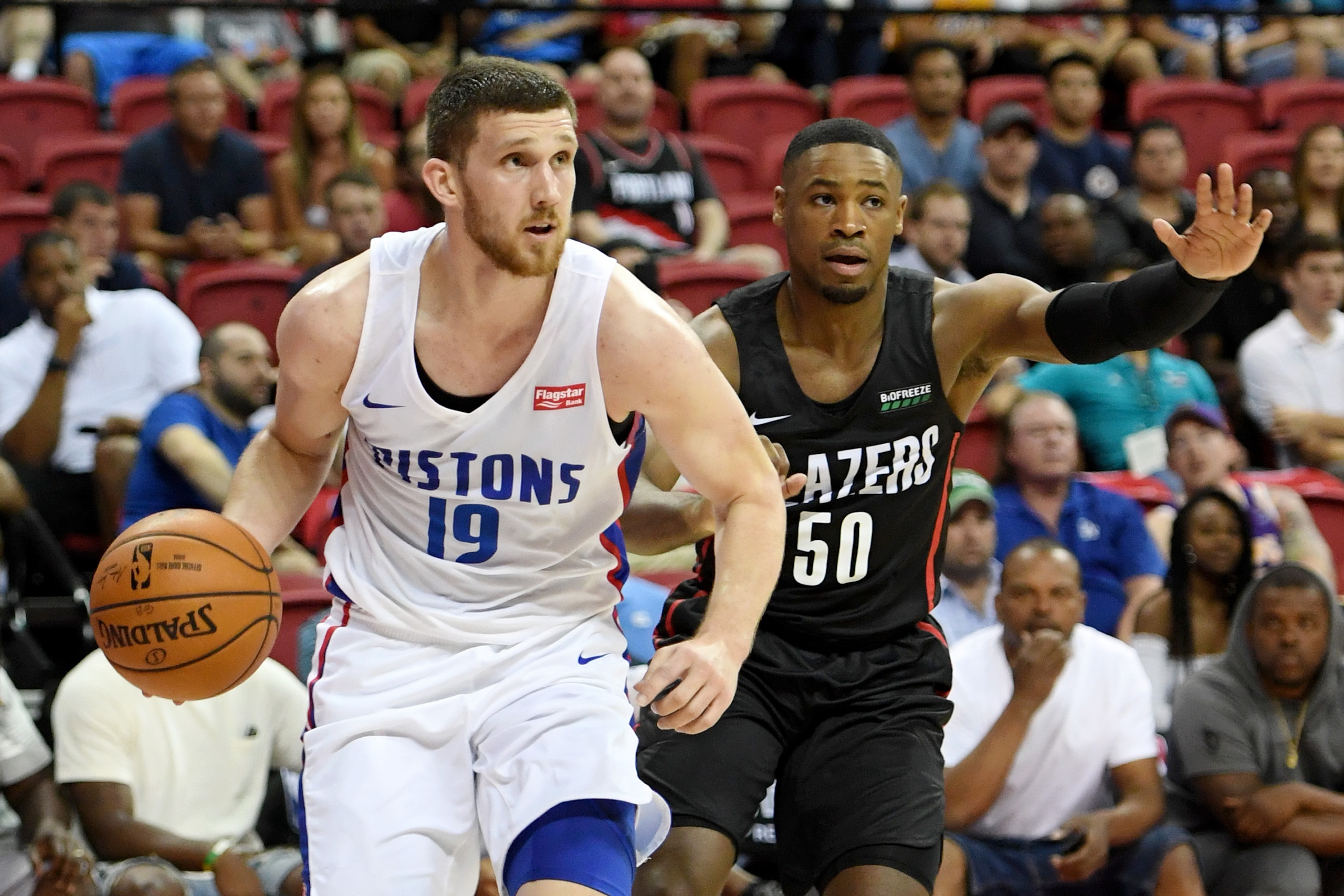 LAS VEGAS, NEVADA - JULY 06:  Sviatoslav Mykhailiuk #19 of the Detroit Pistons drives against Demetrius Jackson #50 of the Portland Trail Blazers during the 2019 NBA Summer League at the Thomas & Mack Center on July 6, 2019 in Las Vegas, Nevada. The Pisto