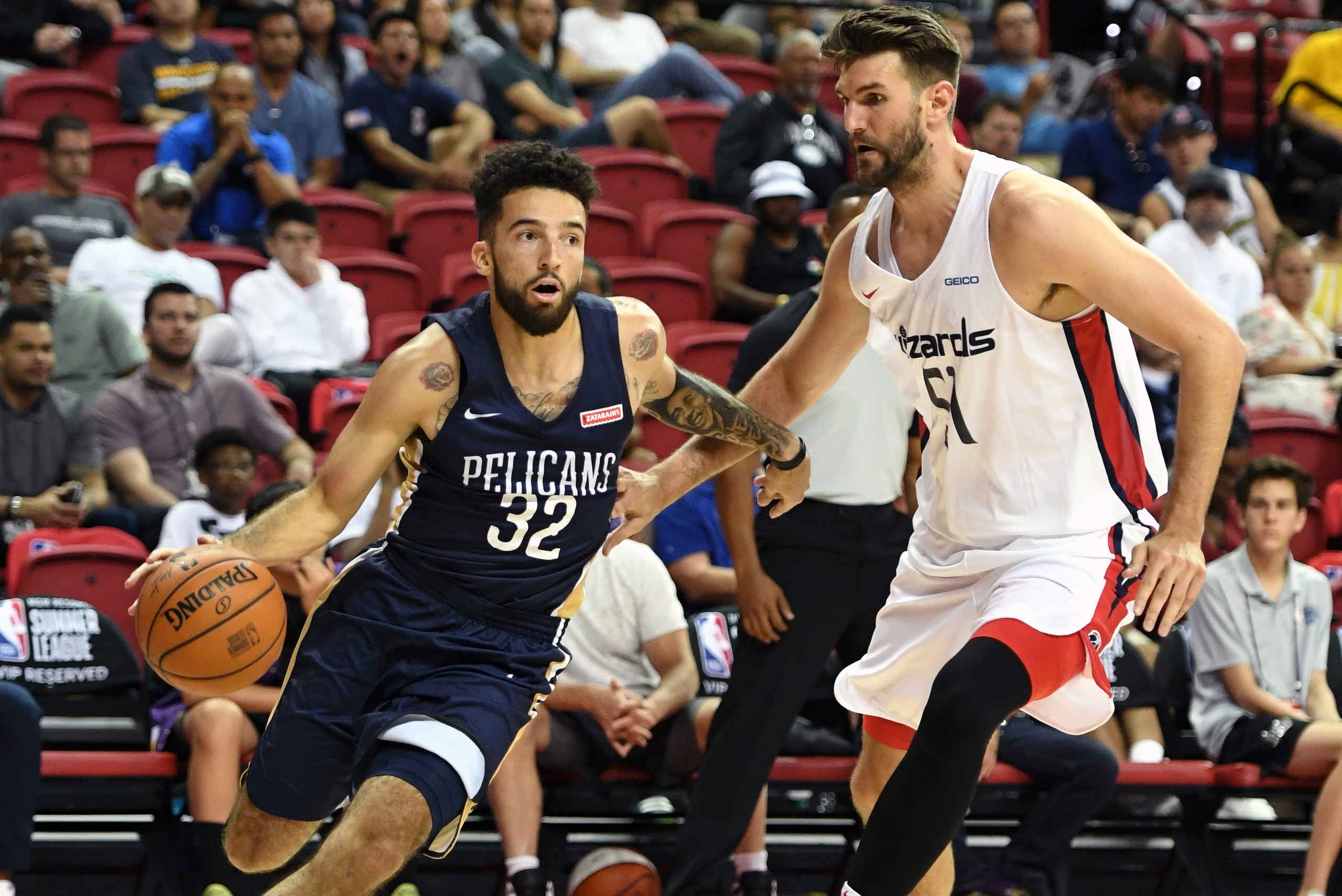 LAS VEGAS, NEVADA - JULY 06:  London Perrantes #32 of the New Orleans Pelicans drives against Jeff Withey #51 of the Washington Wizards during the 2019 NBA Summer League at the Thomas & Mack Center on July 6, 2019 in Las Vegas, Nevada. NOTE TO USER: User 