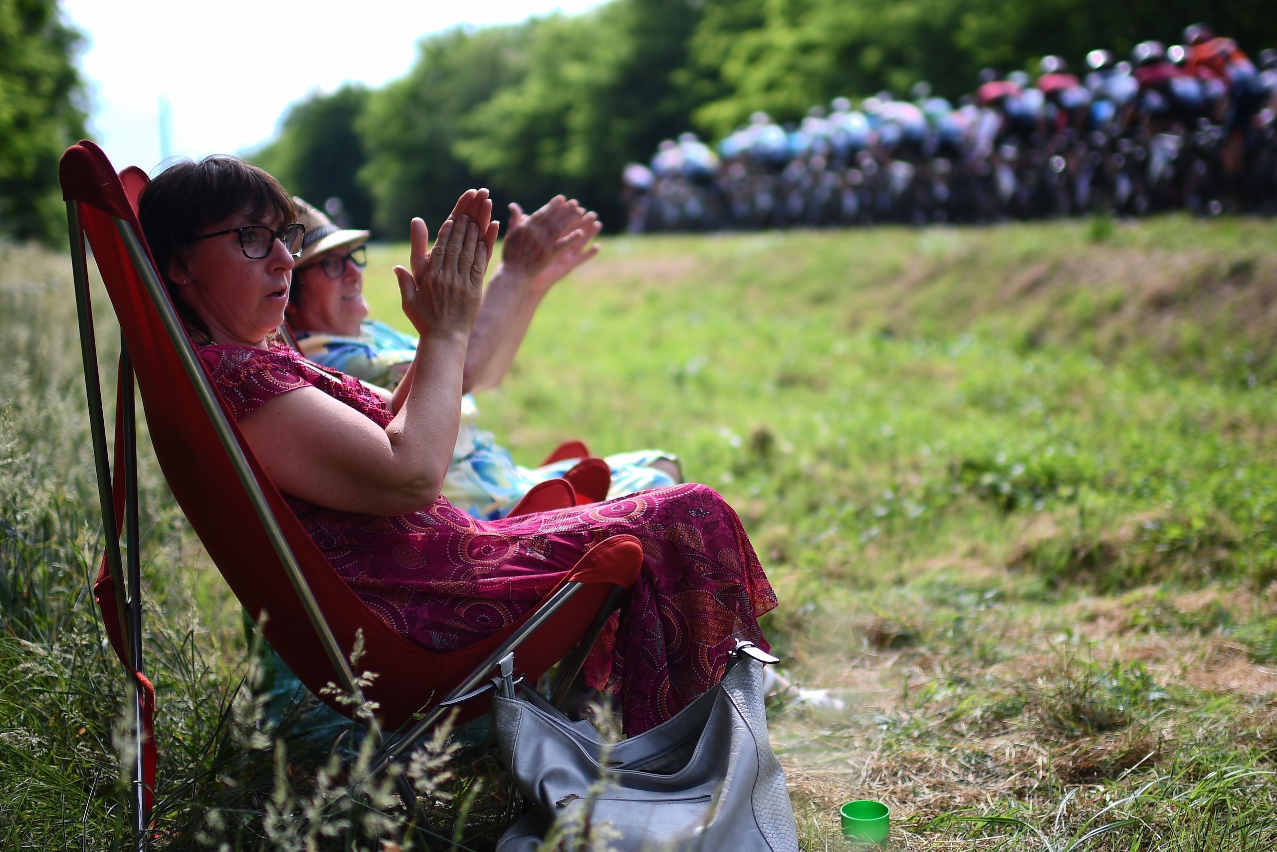 Cyclism enthusiasts applaud cyclists passing during the seventh stage of the 106th edition of the Tour de France cycling race between Belfort and Chalon-sur-Saone, on July 12, 2019. (Photo by Anne-Christine POUJOULAT / AFP)        (Photo credit should rea