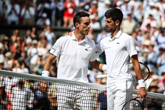 LONDON, ENGLAND - JULY 12: Novak Djokovic(R) of Serbia greets Roberto Bautista Agut of Spain after their Men's Singles semi-final match during Day eleven of The Championships - Wimbledon 2019 at All England Lawn Tennis and Croquet Club on July 12, 2019 in