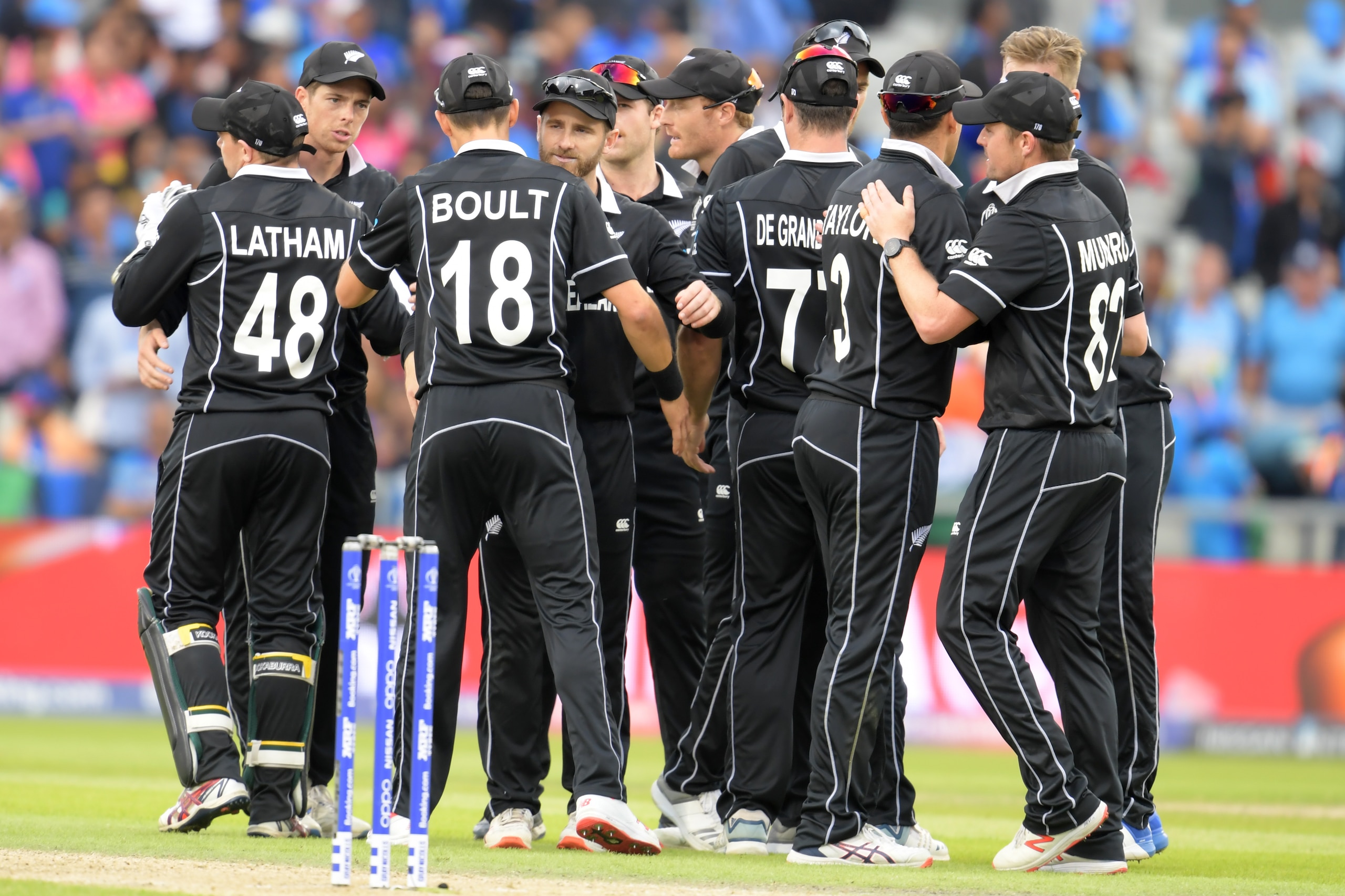New Zealand's captain Kane Williamson (C) and teammates celebrate victory during the 2019 Cricket World Cup first semi-final between New Zealand and India at Old Trafford in Manchester, northwest England, on July 10, 2019. - New Zealand beat India by 18 r