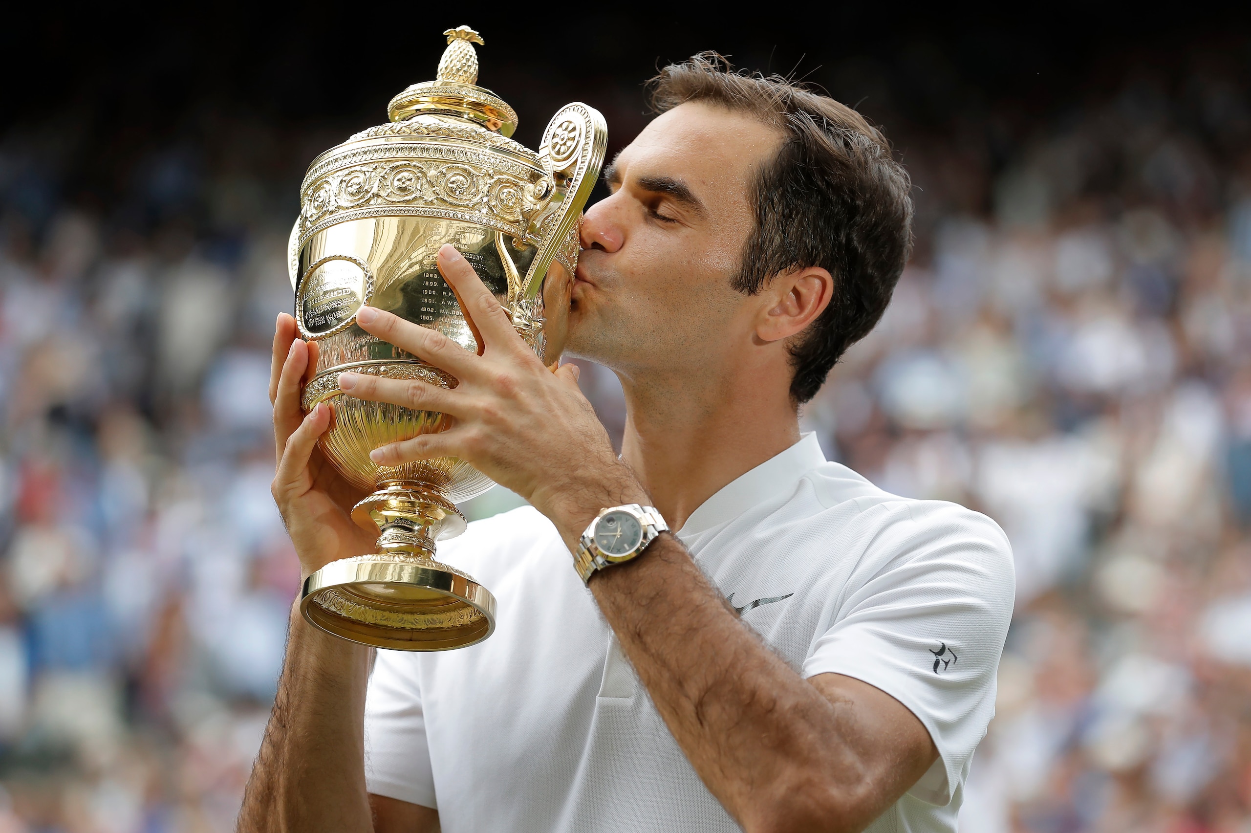 LONDON,UNITED KINGDOM - JULY 16:  Roger Federer kisses the trophy after winning the men's singles final against Marin Cilic on Centre Court on day thirteen of the 2017 Wimbledon tennis championships at the All England Lawn Tennis Club on July 16th 2017 in