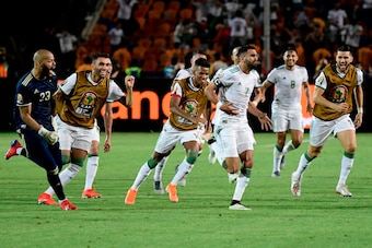 Algeria's players celebrate their winning goal during the 2019 Africa Cup of Nations (CAN) Semi-final football match between Algeria and Nigeria at the Cairo International stadium in Cairo on July 14, 2019. (Photo by JAVIER SORIANO / AFP)        (Photo cr