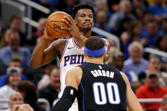 ORLANDO, FL - MARCH 25: Jimmy Butler #23 of the Philadelphia 76ers is defended by Aaron Gordon #00 of the Orlando Magic during the game at the Amway Center on March 25, 2019 in Orlando, Florida. The Magic defeated the 76ers 119 to 98. NOTE TO USER: User e