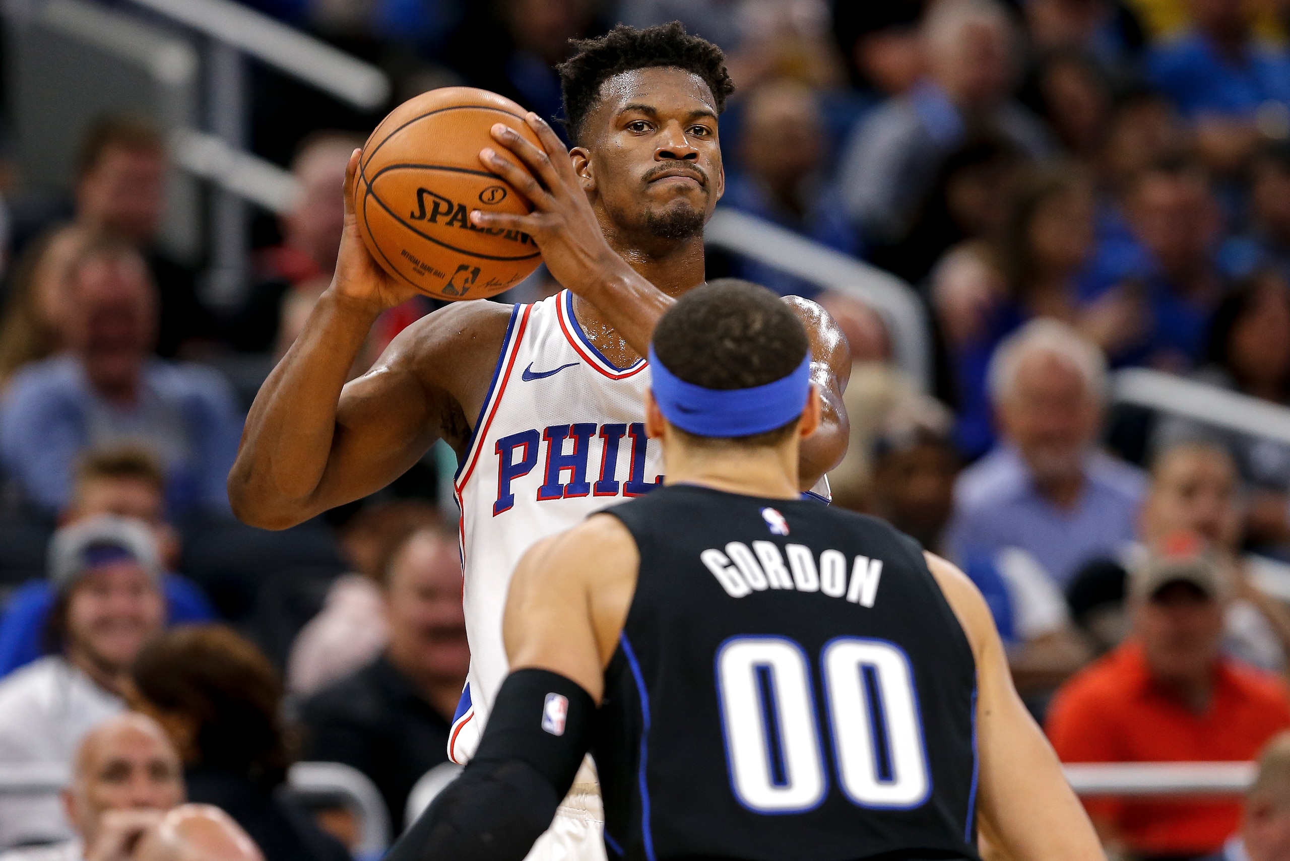 ORLANDO, FL - MARCH 25: Jimmy Butler #23 of the Philadelphia 76ers is defended by Aaron Gordon #00 of the Orlando Magic during the game at the Amway Center on March 25, 2019 in Orlando, Florida. The Magic defeated the 76ers 119 to 98. NOTE TO USER: User e